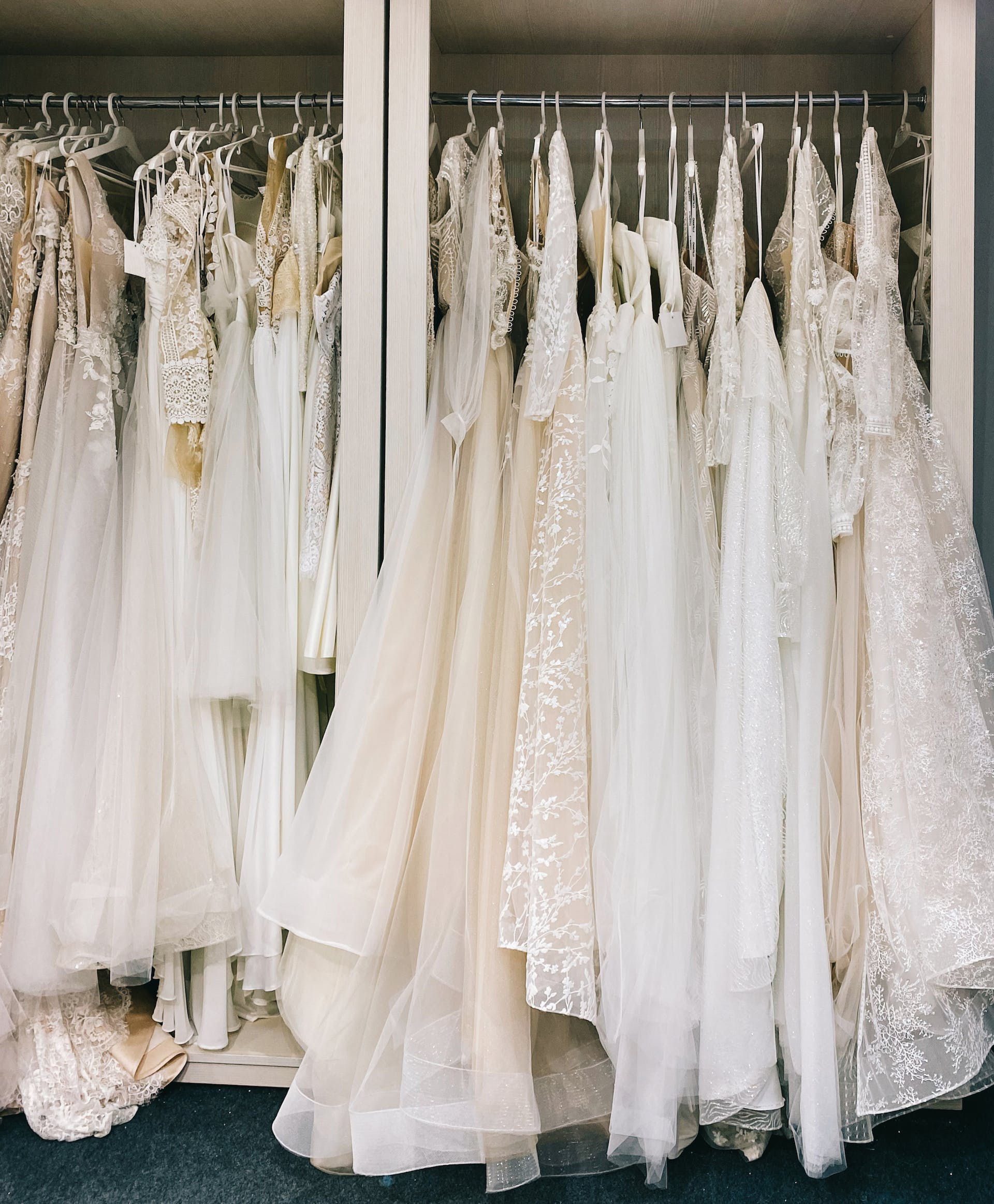 Wedding dresses hanging in a shop | Source: Pexels