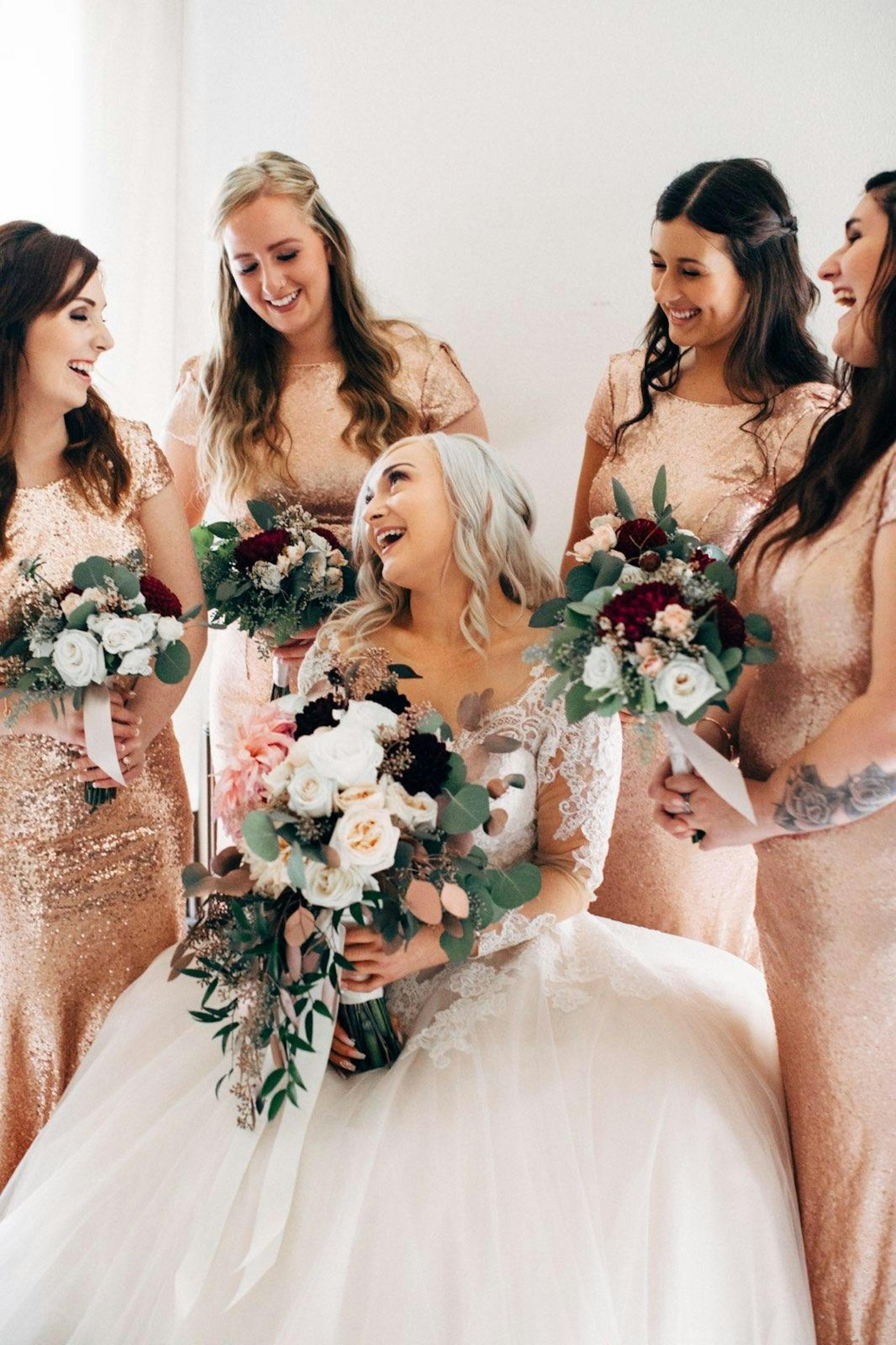A happy bride and her bridesmaids holding bouquets | Source: Pexels