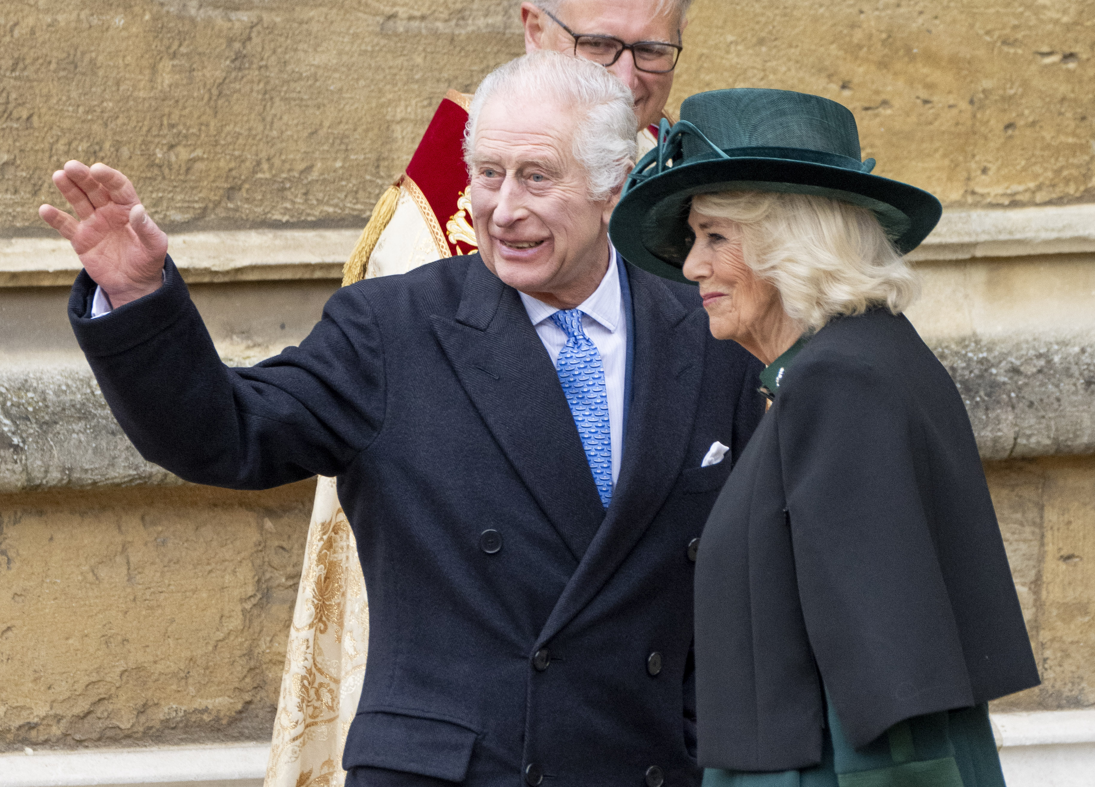 King Charles waving at the crowd alongside Queen Camilla as they attend the Easter Sunday service in ST. George's Chapel on March 31, 2024 | Source: Getty Images
