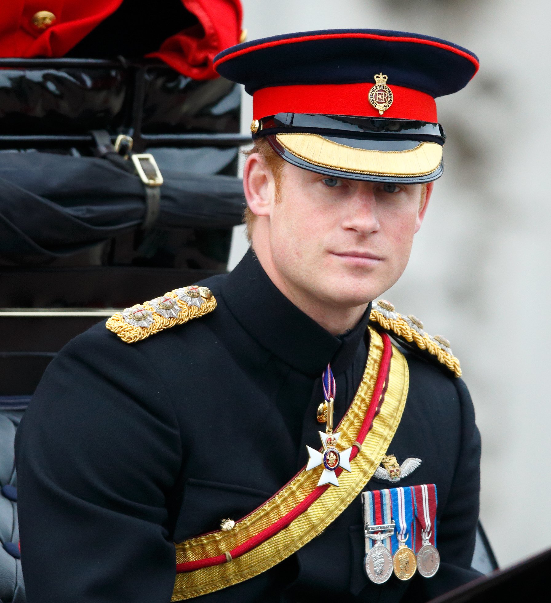 Prince Harry travels down The Mall in a horse-drawn carriage during Trooping the Colour on June 13, 2015, in London, England. | Source: Getty Images