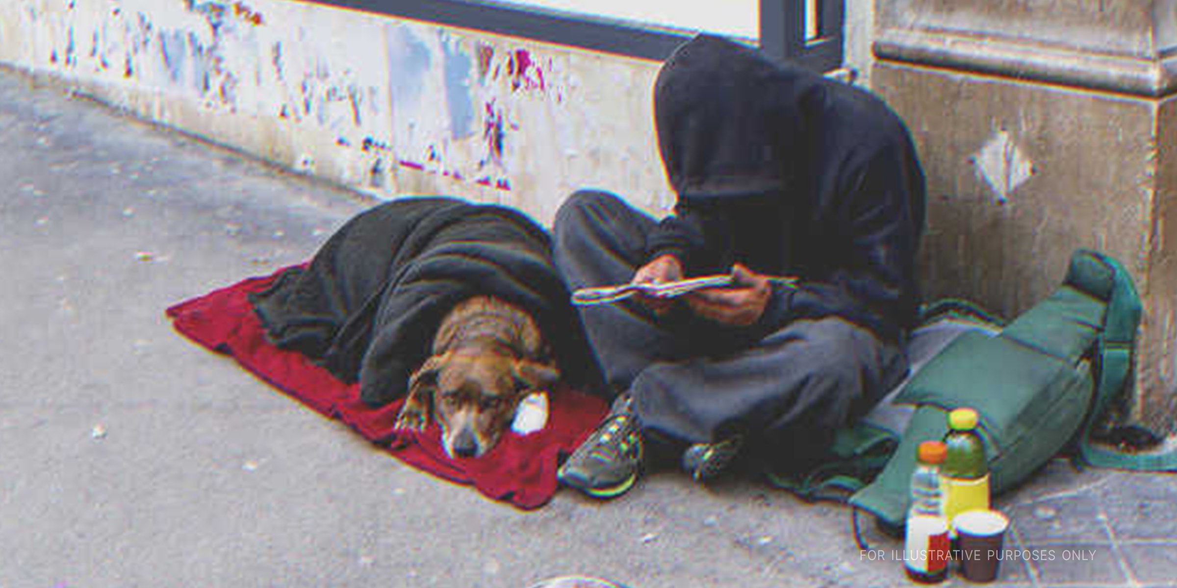 Homeless man sitting on the street with a dog | Source: Shutterstock