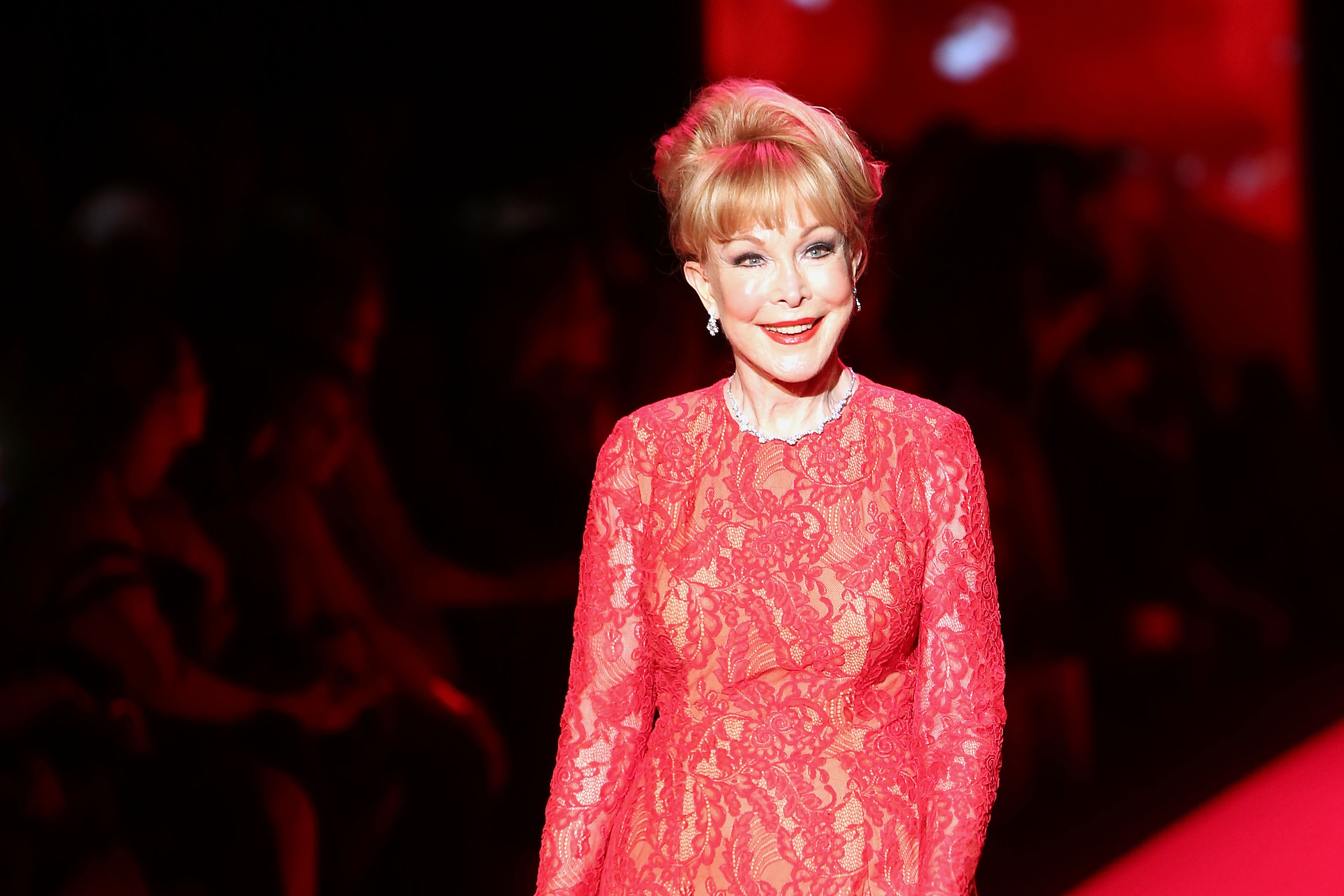 Barbara Eden lights up the runway in a red lace gown during the Go Red For Women fall fashion show in New York City.