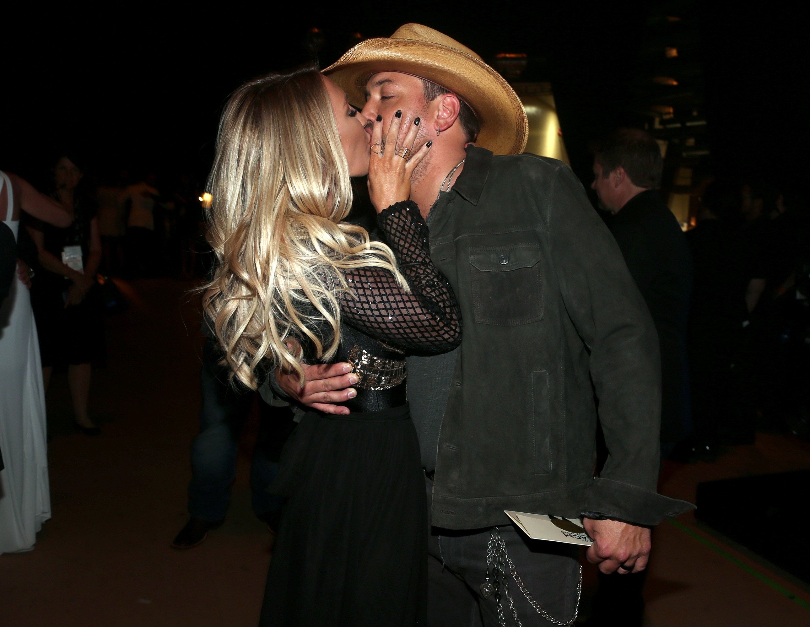 Brittany Kerr and Jason Aldean, winner of the Entertainer of the Year award, kiss at the 51st Academy of Country Music Awards at MGM Grand Garden Arena on April 3, 2016 in Las Vegas, Nevada | Source: Getty Images