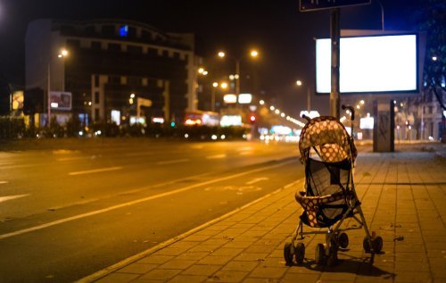Abandoned baby stroller at night. | Source: Shutterstock