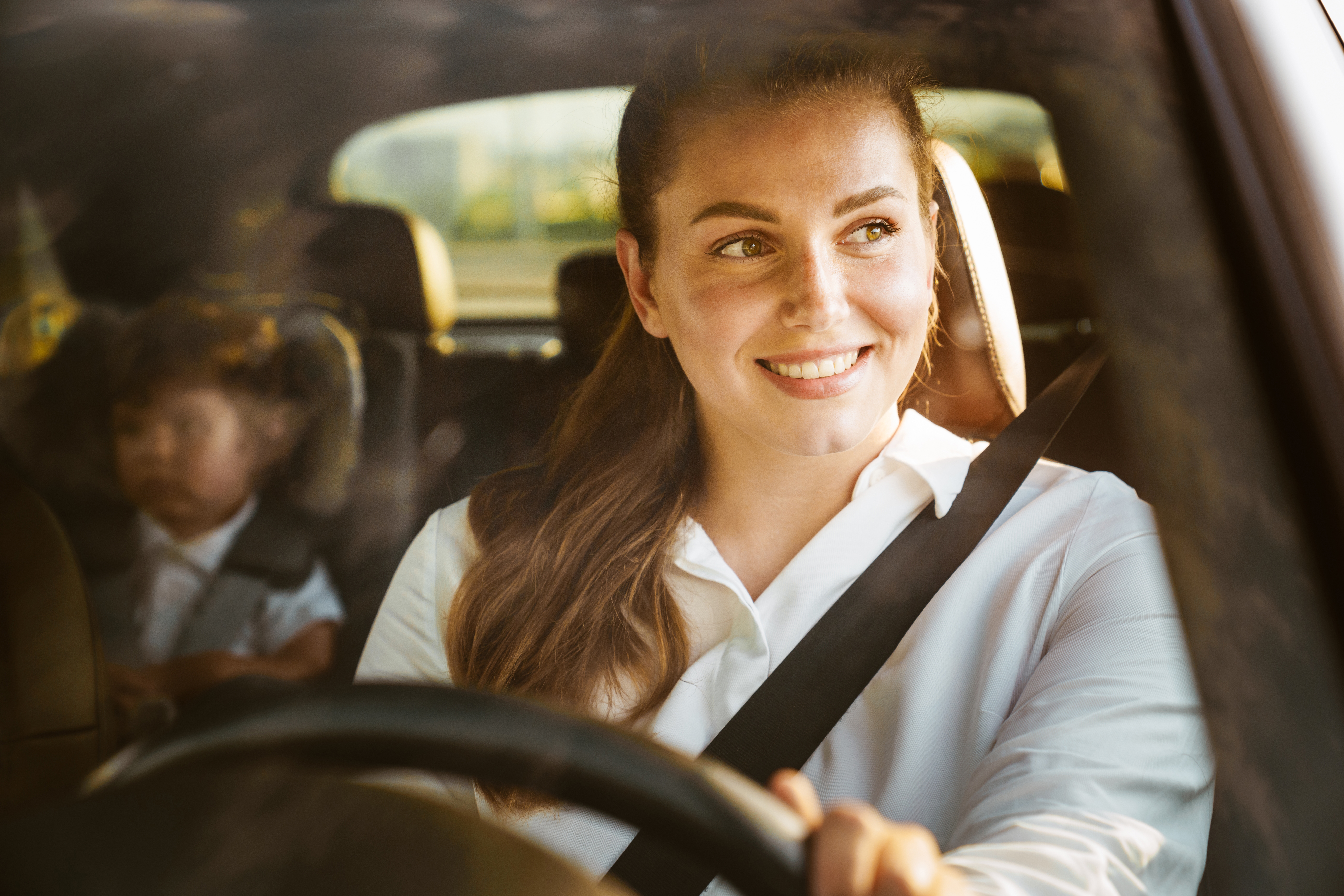 Young white woman driving car | Source: Shutterstock