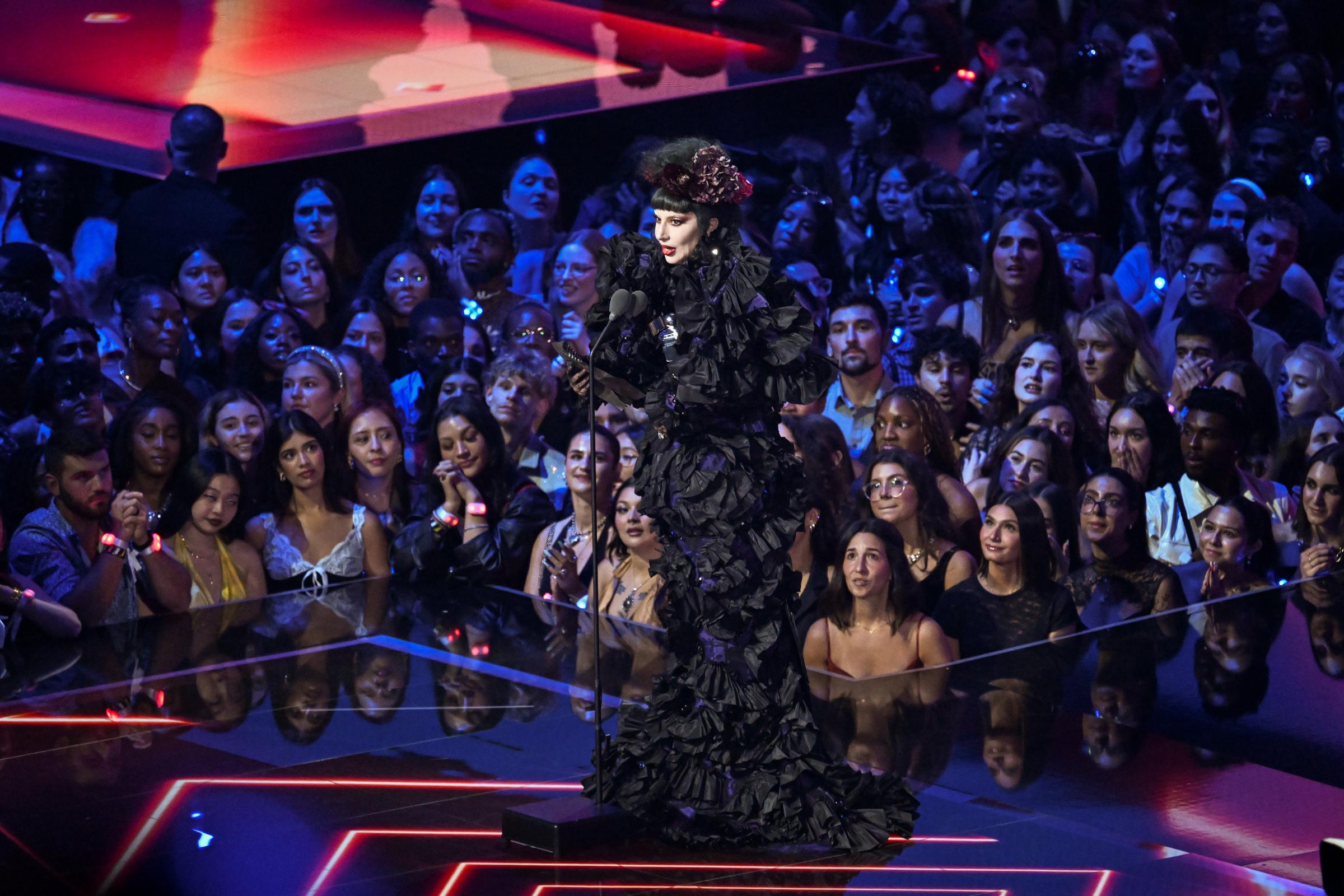 Lady Gaga speaks onstage as she is surrounded by the audience during the 2025 MTV Video Music Awards | Source: Getty Images