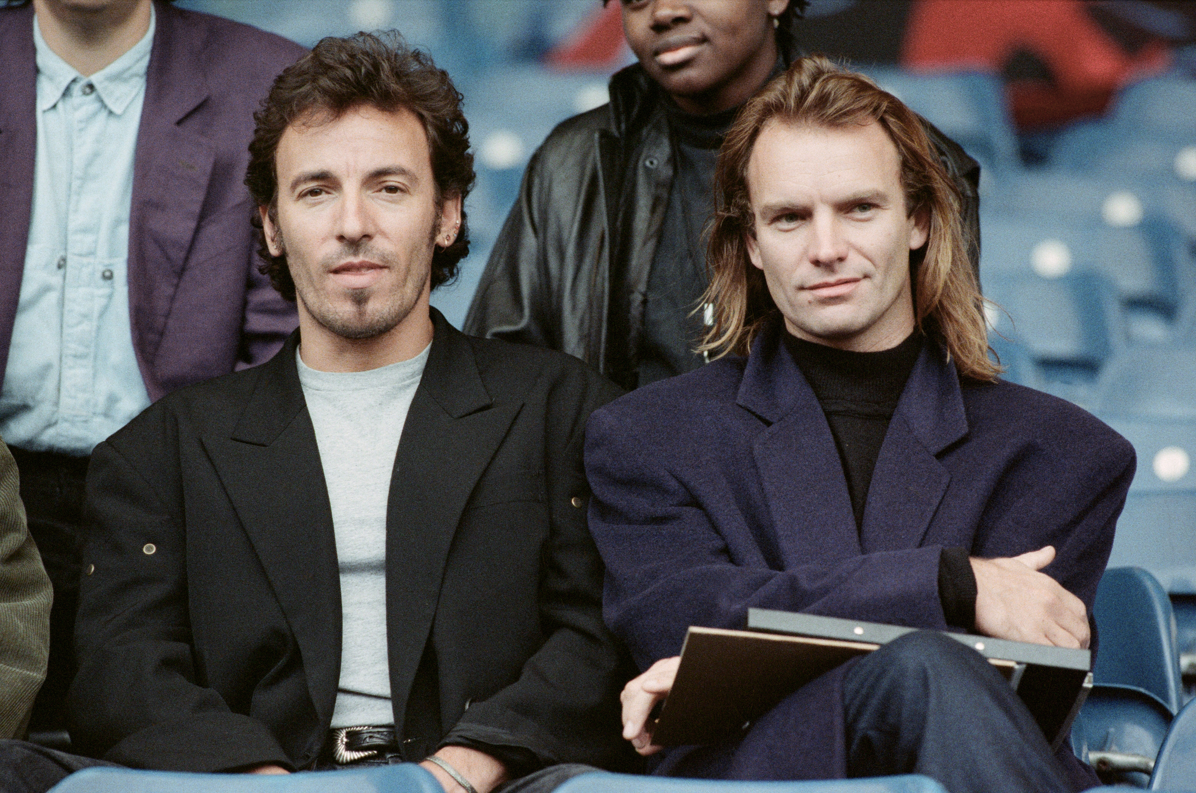 In this 1988 snapshot, Sting and Bruce Springsteen are seen side by side, both dressed casually as they share a candid moment backstage. The photo reflects their long-standing friendship during the height of their careers.