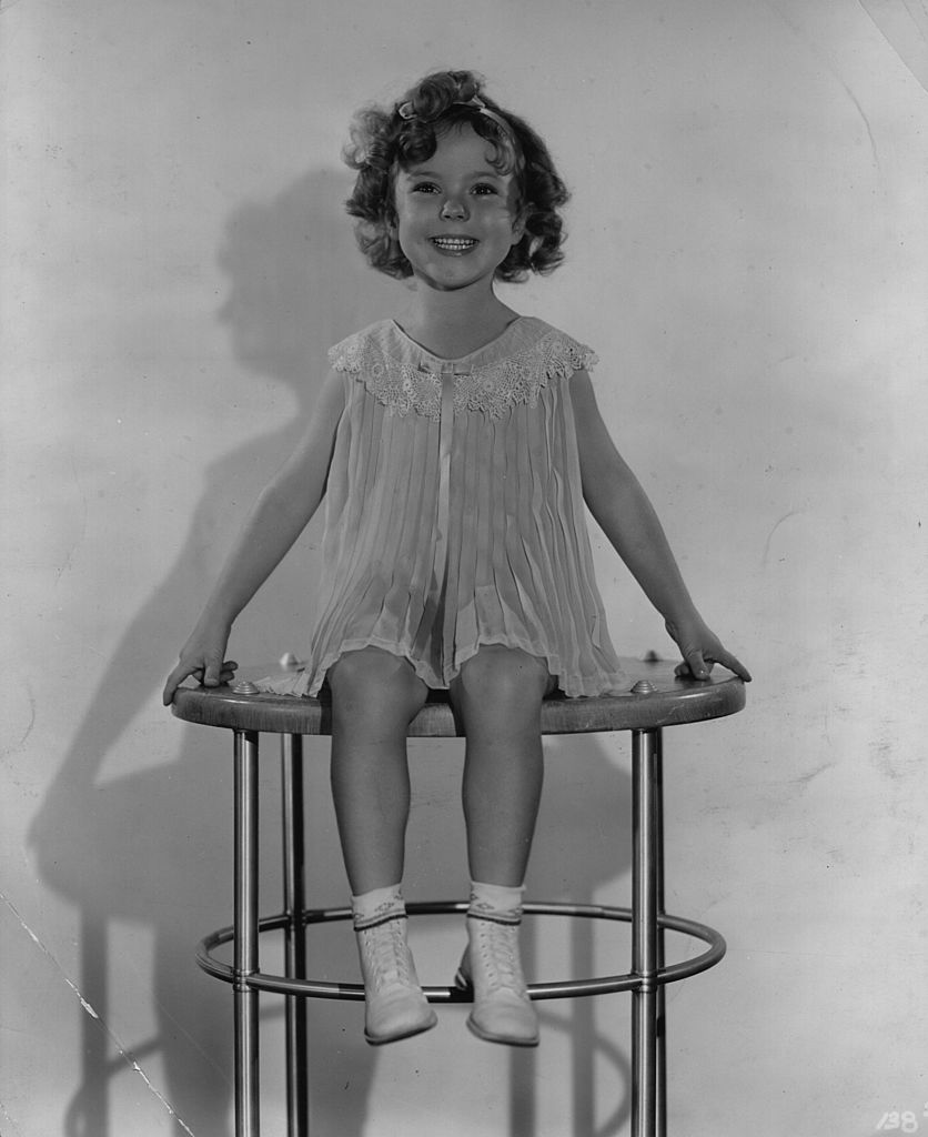 Shirley Temple smiles brightly at the camera | Getty Images