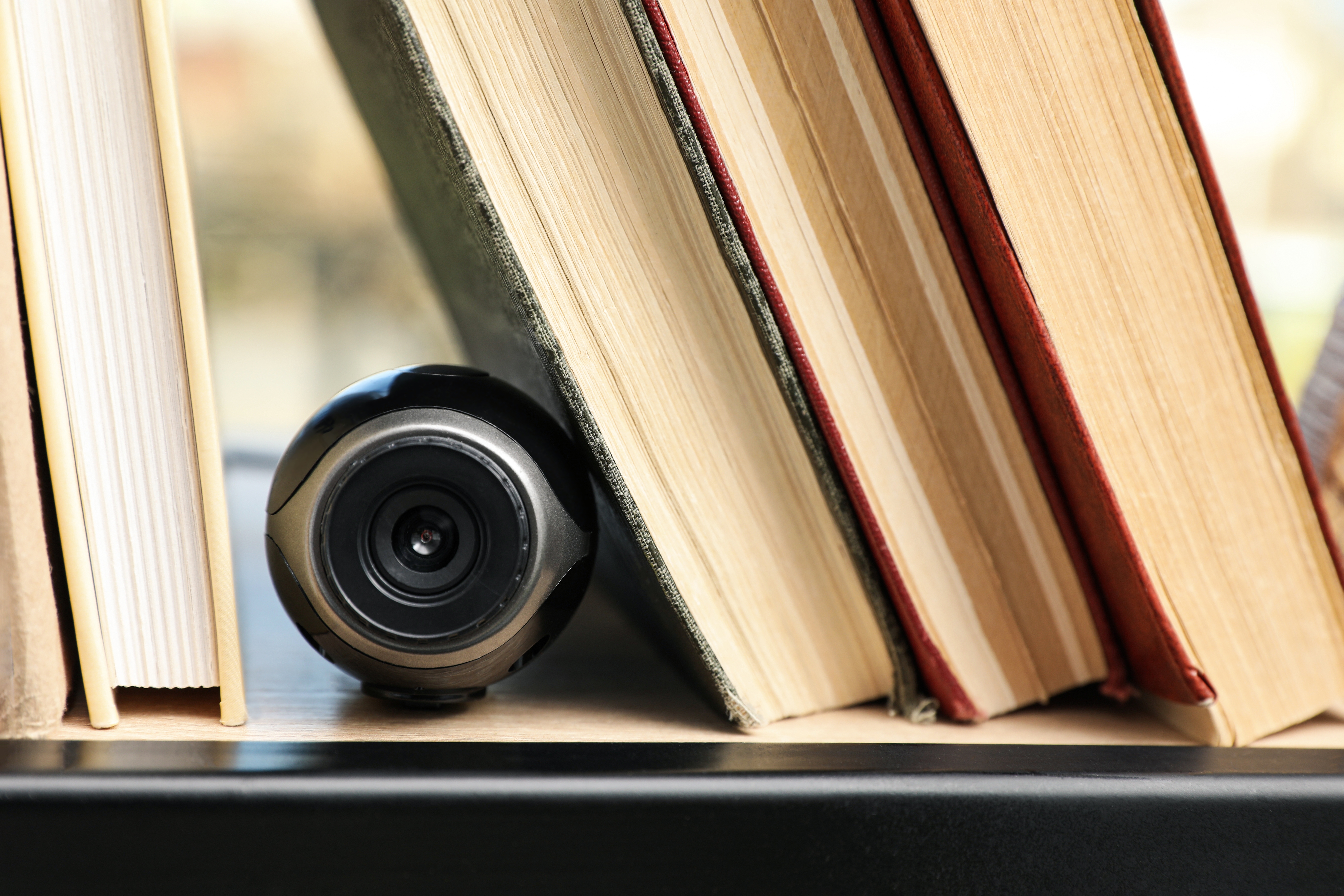 A camera hidden amongst books | Source: Shutterstock