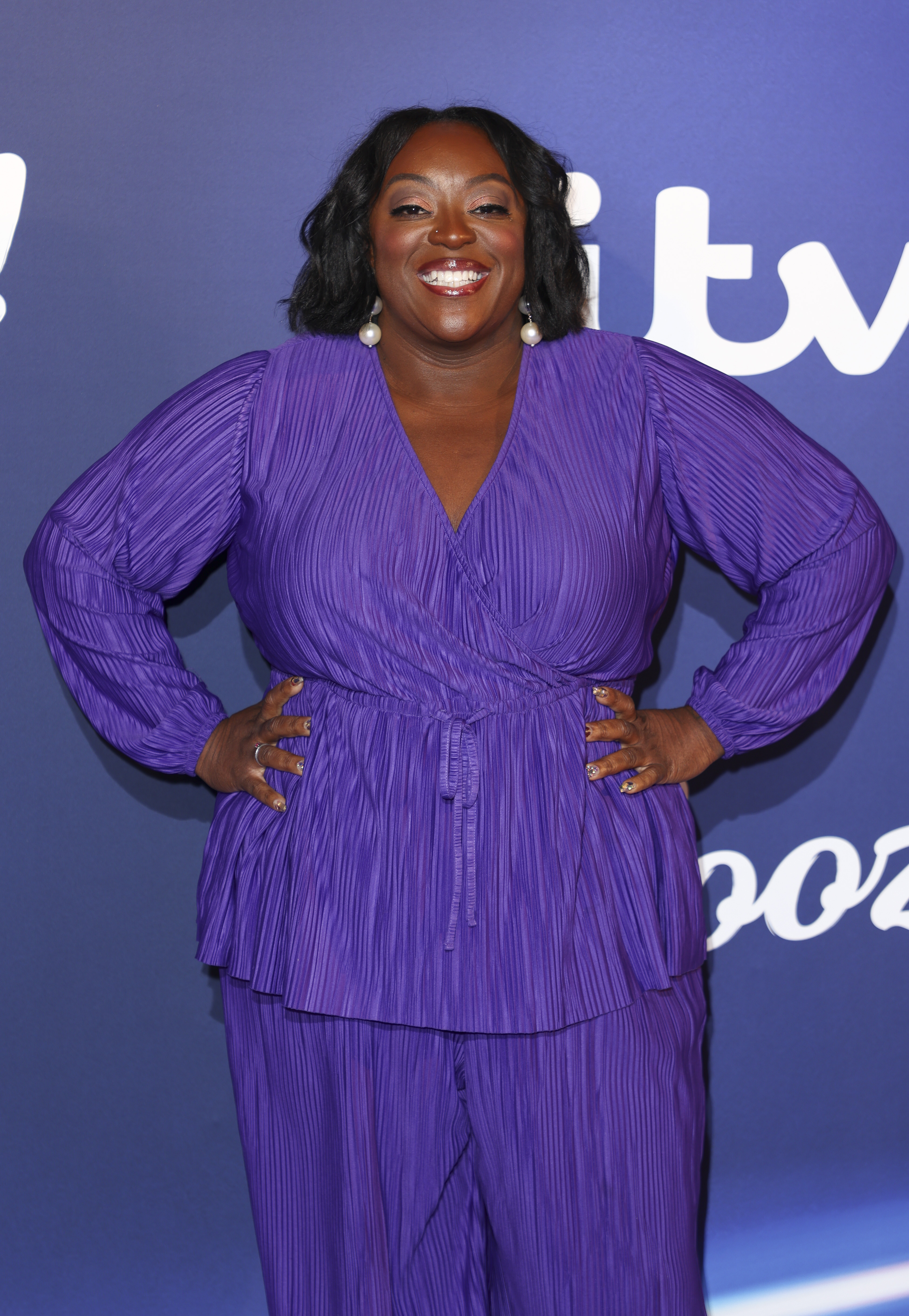 Lighting up the blue carpet with her signature flair, Love dazzles at ITV Palooza at Theatre Royal Drury Lane. The presenter radiates in a vibrant purple pleated outfit, finished with statement pearl drop earrings and a megawatt smile, as she joins the glittering celebration of the broadcaster's biggest stars.