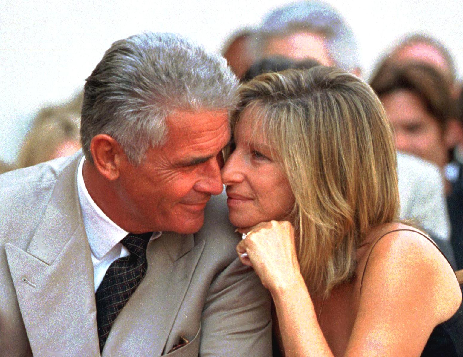 US actor James Brolin and his singer-actress wife Barbra Streisand share a tender moment during the Hollywood Walk of Fame ceremony for Brolin in Hollywood, California. | Source: Getty Images 