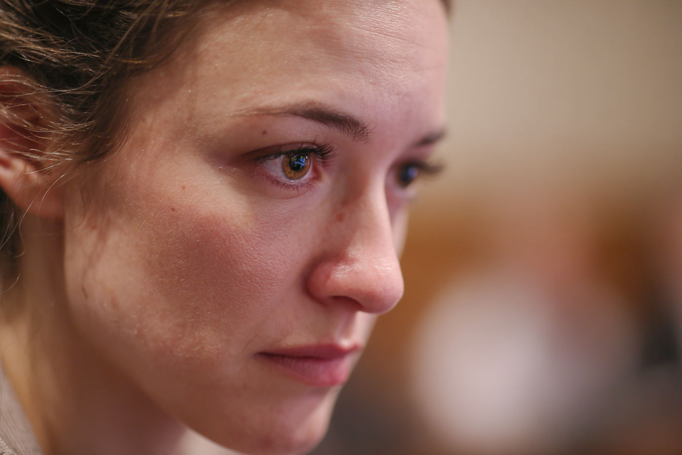 A woman in a courtroom | Source: Midjourney