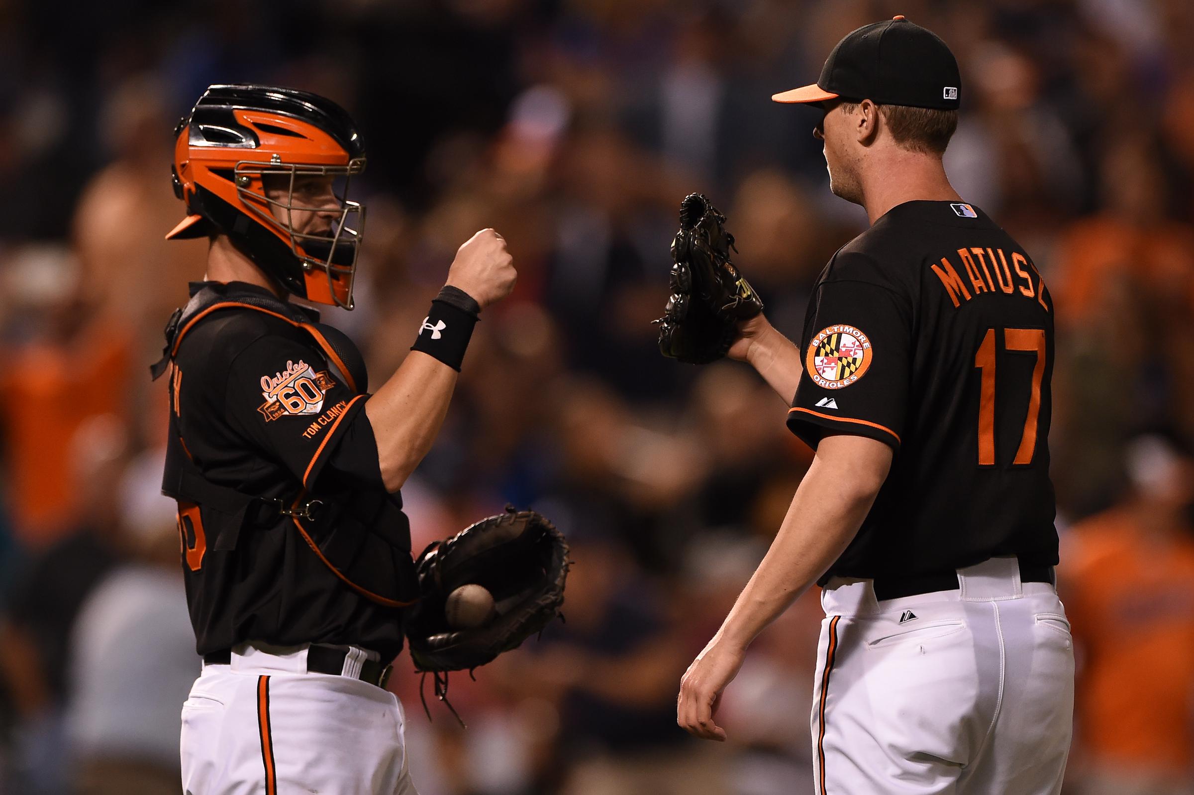 Brian Matusz of the Baltimore Orioles celebrates with Caleb Joseph after defeating the New York Yankees during game two of a doubleheader at Oriole Park at Camden Yards in Baltimore, Maryland, on September 12, 2014 | Source: Getty Images