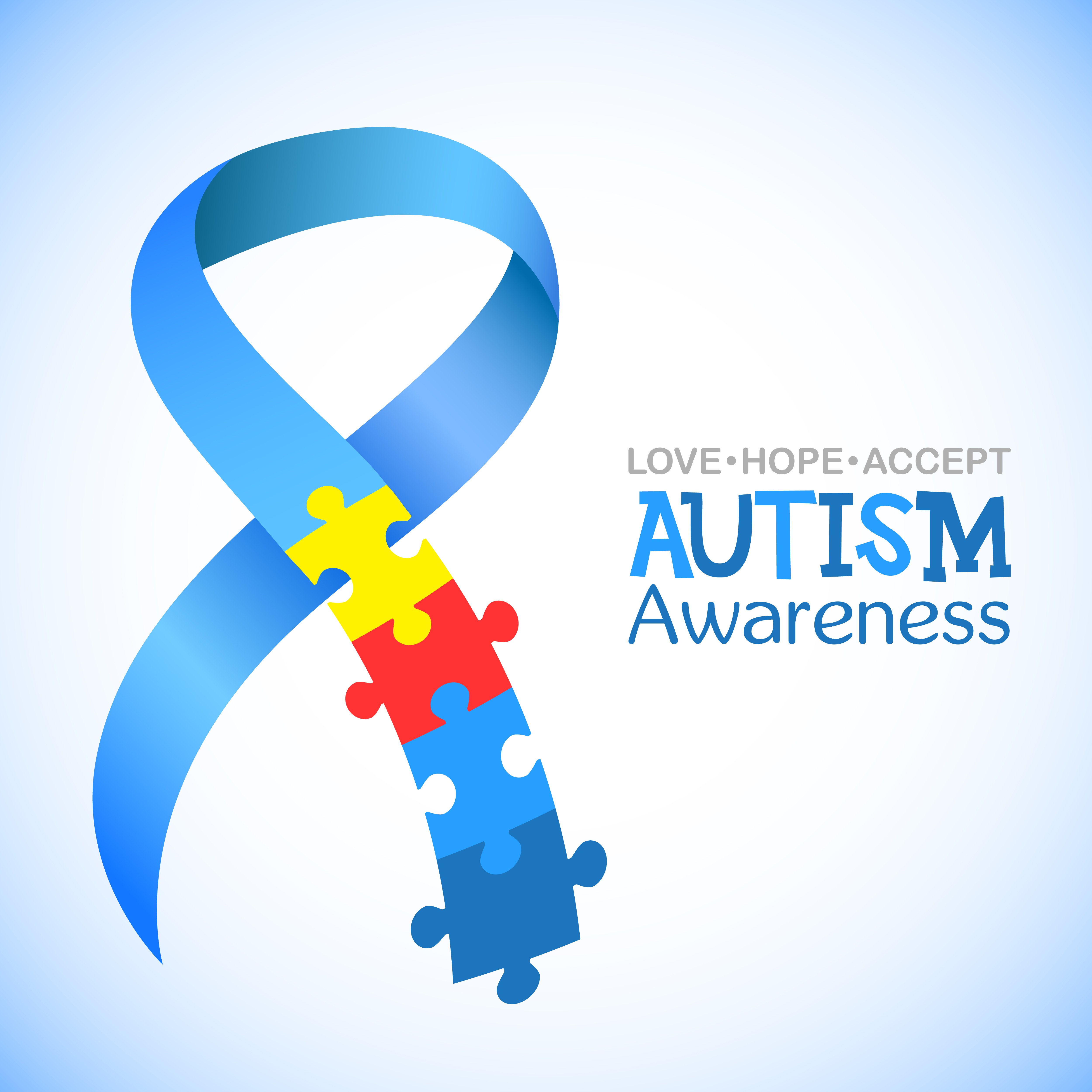 Blue ribbon with colourful puzzles vector background; a symbol of autism. | Source: Shutterstock