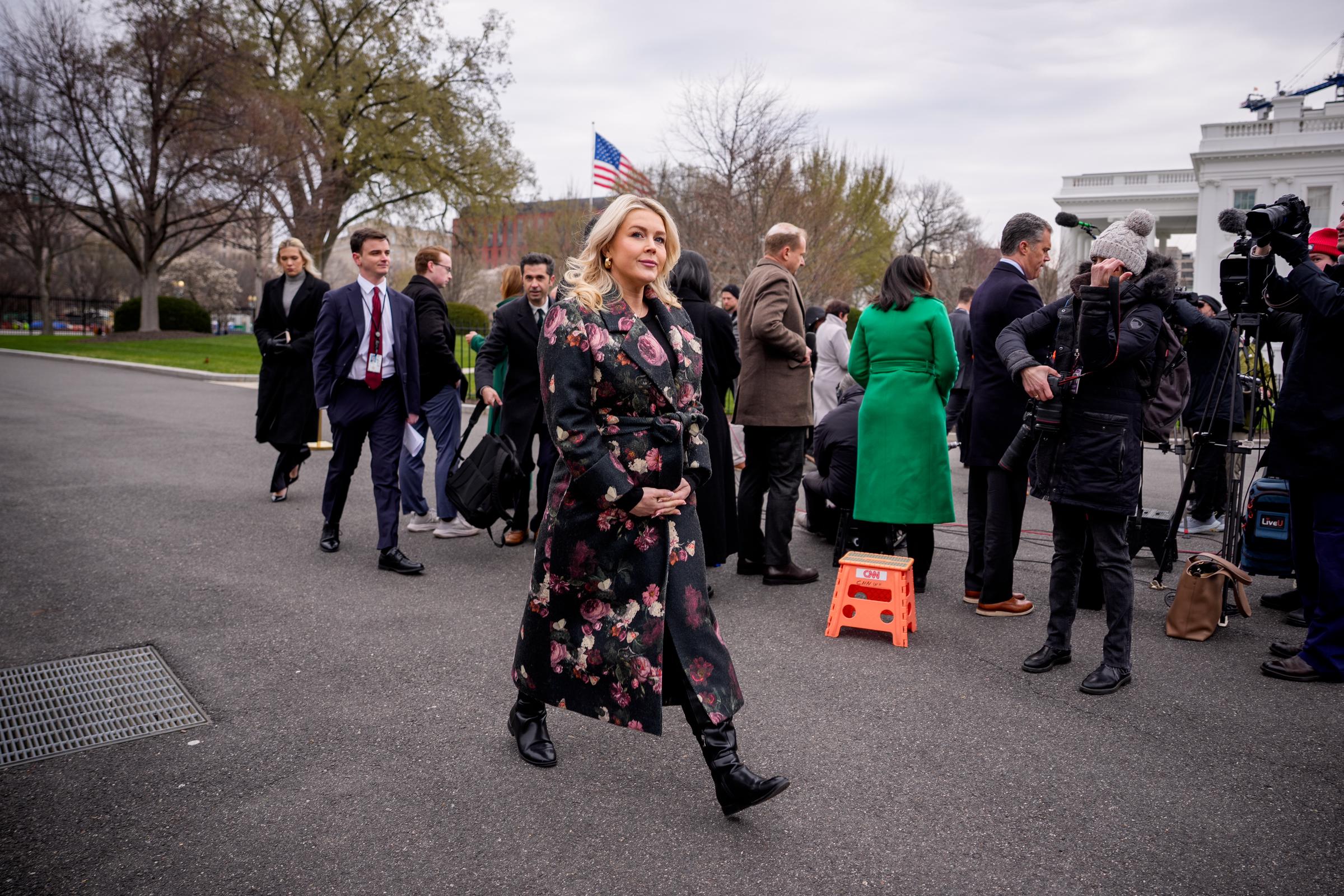 Karoline Leavitt walks back toward the West Wing as members of the press gather behind her | Source: Getty Images