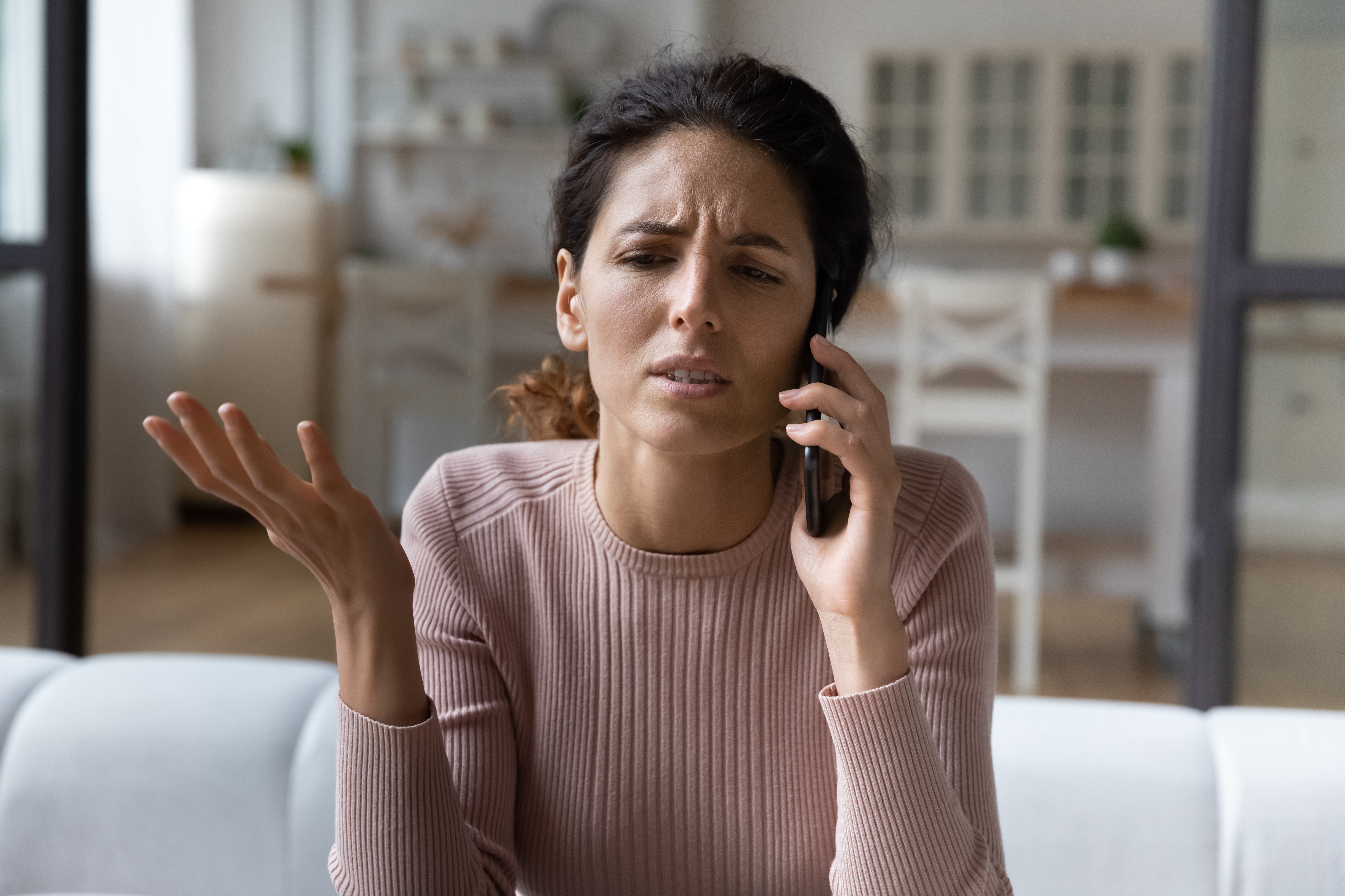 Upset woman talking on the phone | Source: Shutterstock