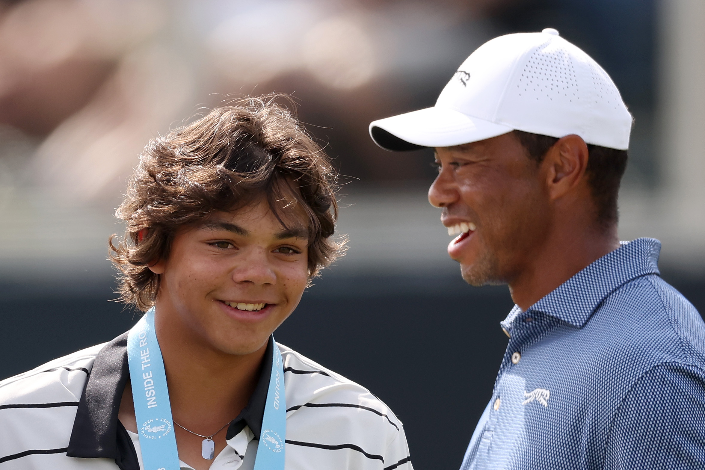 Charlie Woods and Tiger Woods smile during a practice round prior to the U.S. Open at Pinehurst Resort in North Carolina on June 10, 2024. | Source: Getty Images