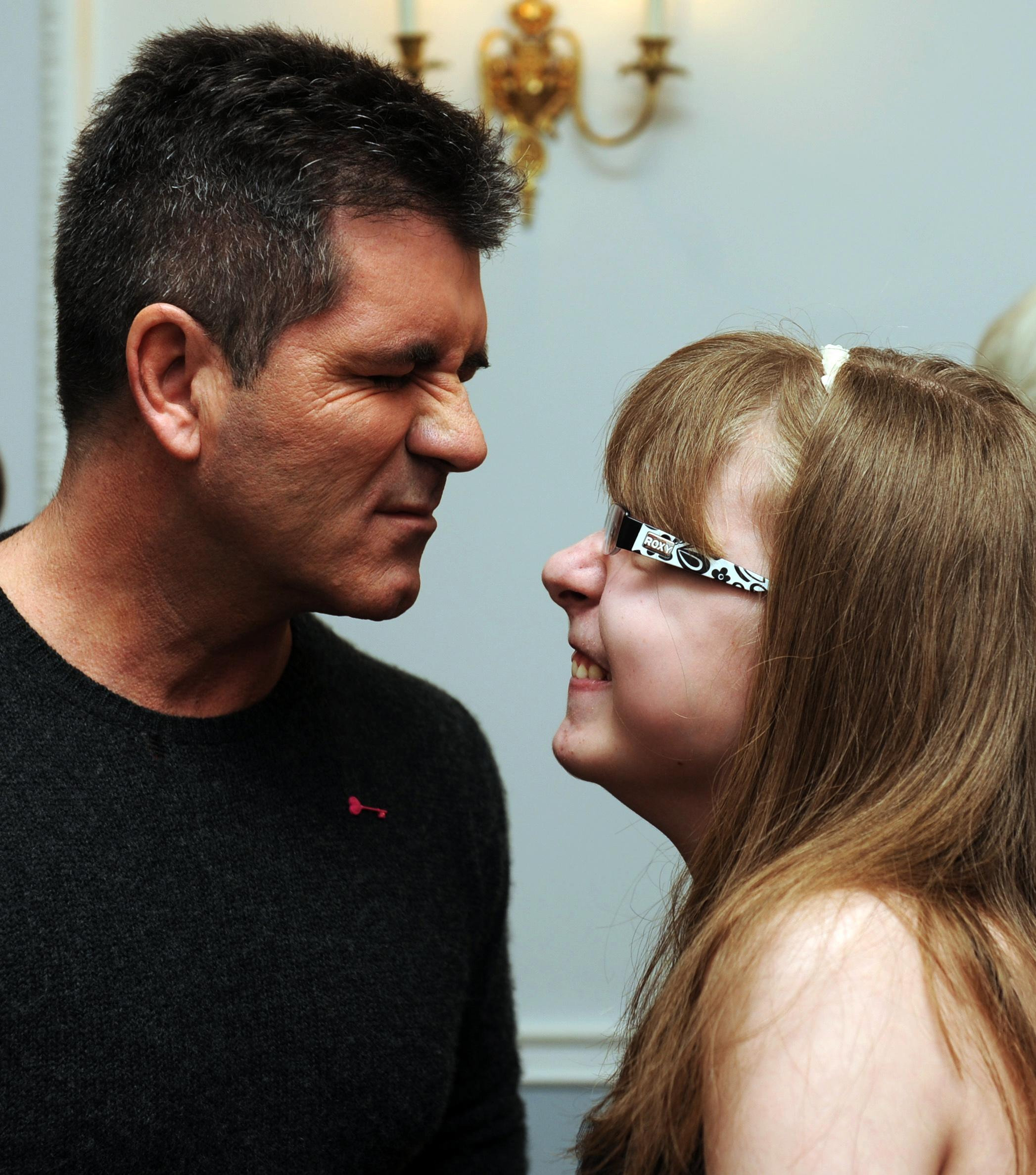 Simon Cowell meets 16 year old Sian Tolfree at a tea party in aid of the children's hospice charity Shooting Star Chase at the Dorchester Hotel in London. | Source: Getty Images