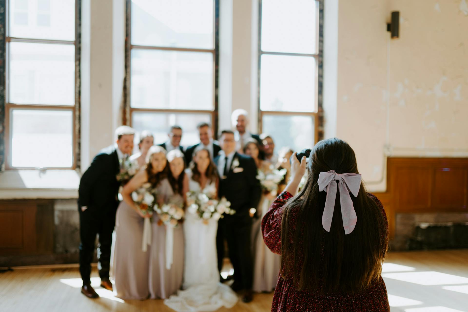 A woman photographing a group at a wedding | Source: Pexels