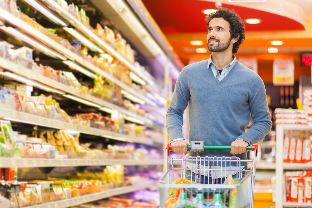 Father shopping in the supermarket. | Source: Shutterstock.com
