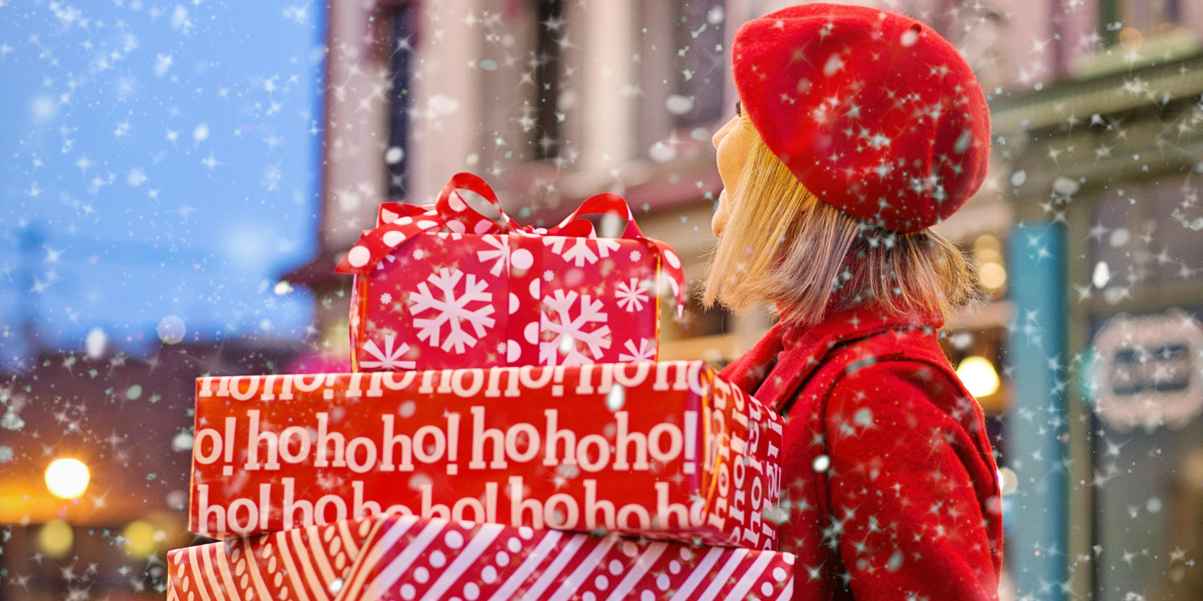 A woman holding up Christmas gifts | Source: Pexels