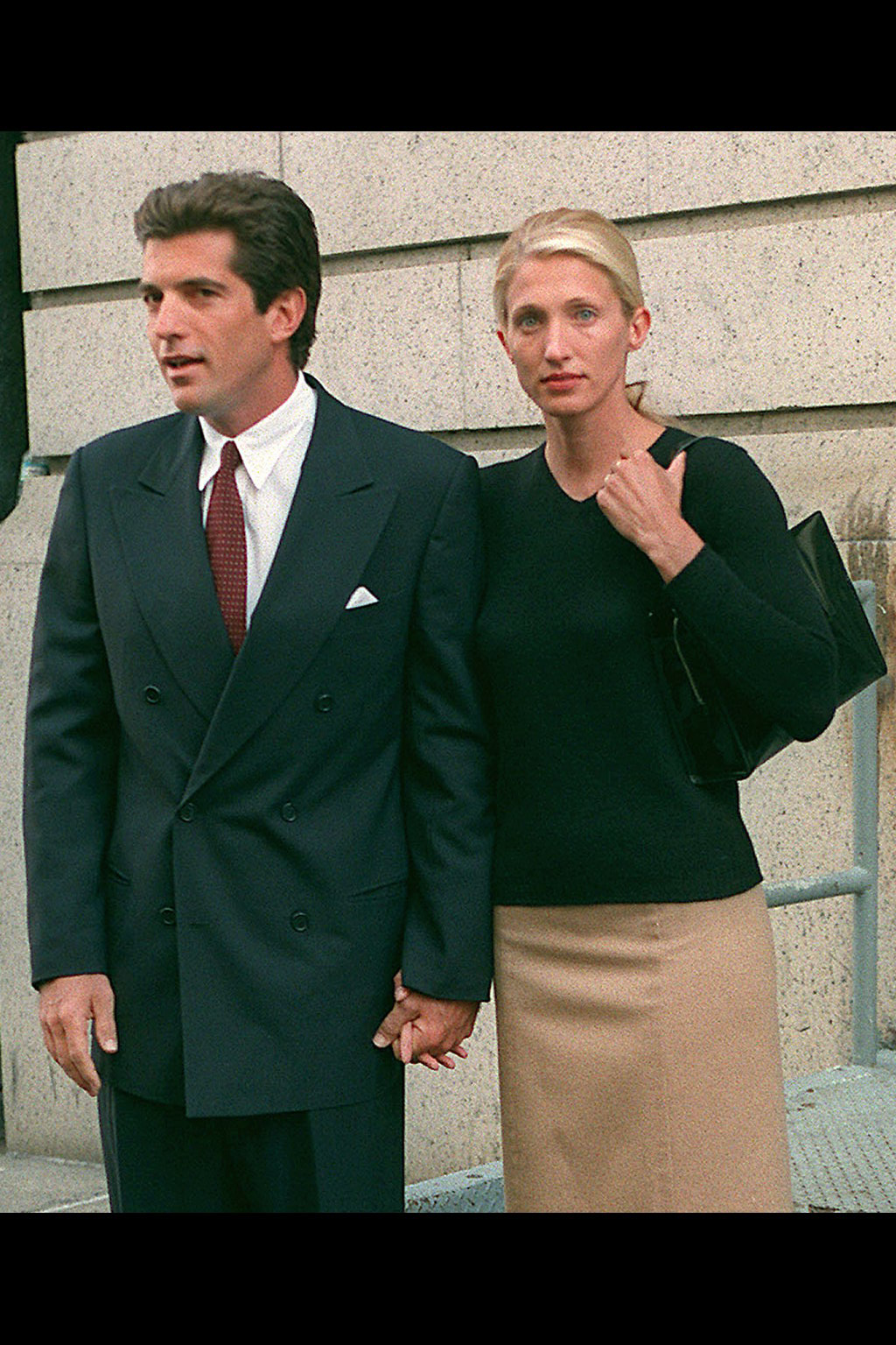 John F. Kennedy Jr. and Carolyn Bessette photographed leaving their New York apartment, circa 1996. | Source: Getty Images