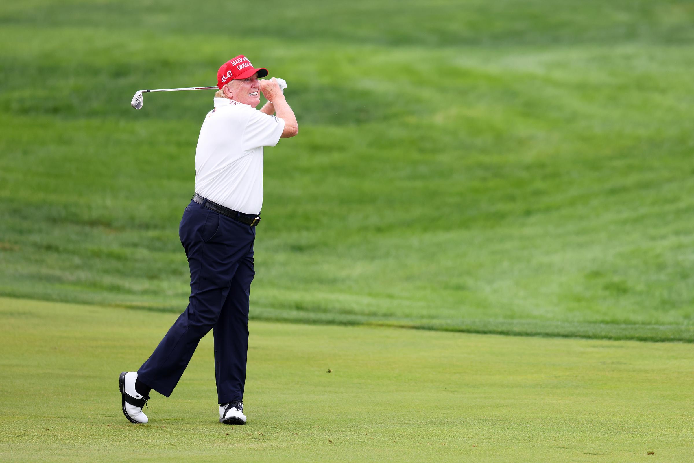 Donald Trump hits his shot from the first fairway during the pro-am prior to the LIV Golf Invitational on August 10, 2023, in Bedminster, New Jersey. | Source: Getty Images