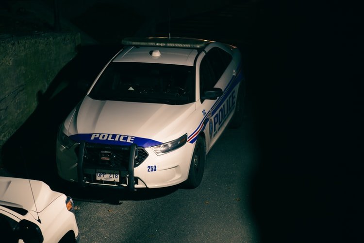 A police car is seen leaving a station | Photo: Unsplash