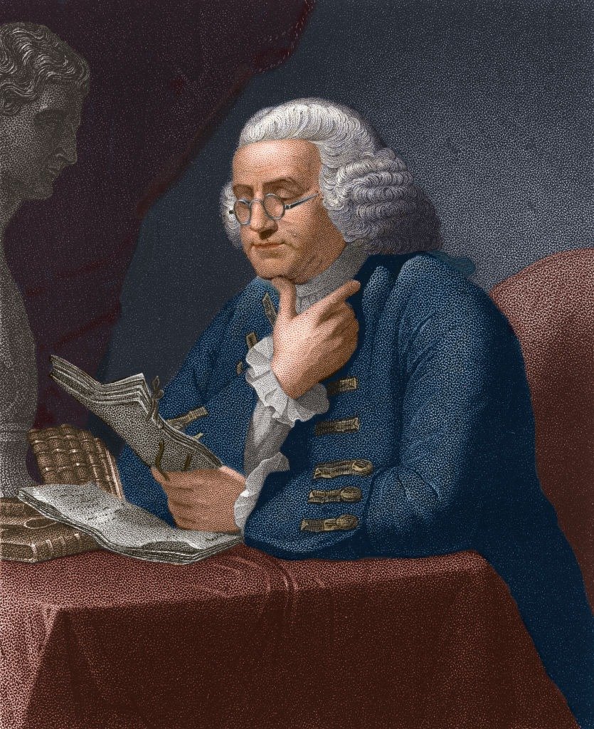 Illustration of American statesman and scientist Benjamin Franklin (1706 - 1790) as he reads at a table, late 18th century. | Photo: Getty Images