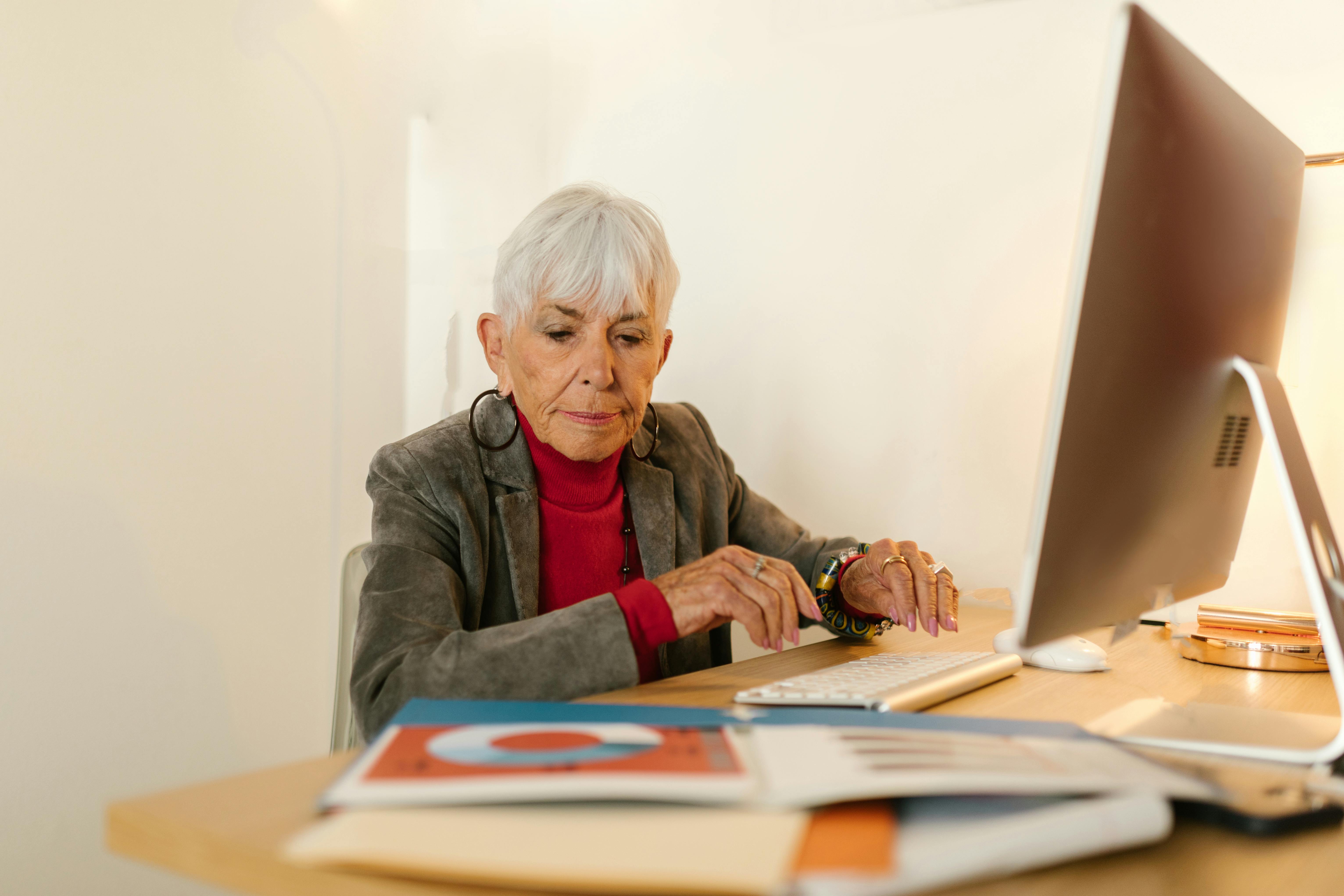 A woman looking down and typing on her computer | Source: Pexels