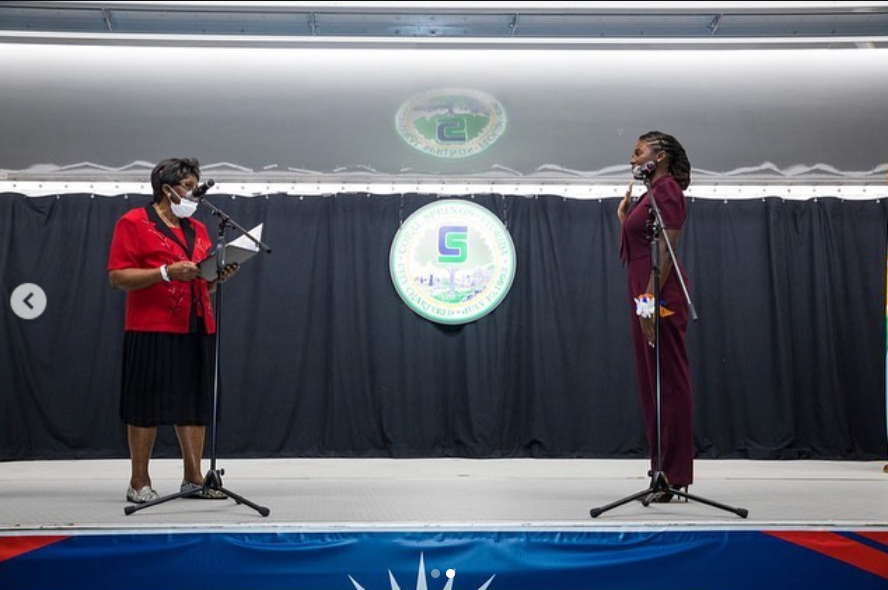 On a formal stage, Nancy Metayer Bowen raises her hand during what appears to be an oath-taking moment, facing an official across from her — an image that captures duty, transition, and the weight of public service. | Source: Instagram/nancymetayerbowen