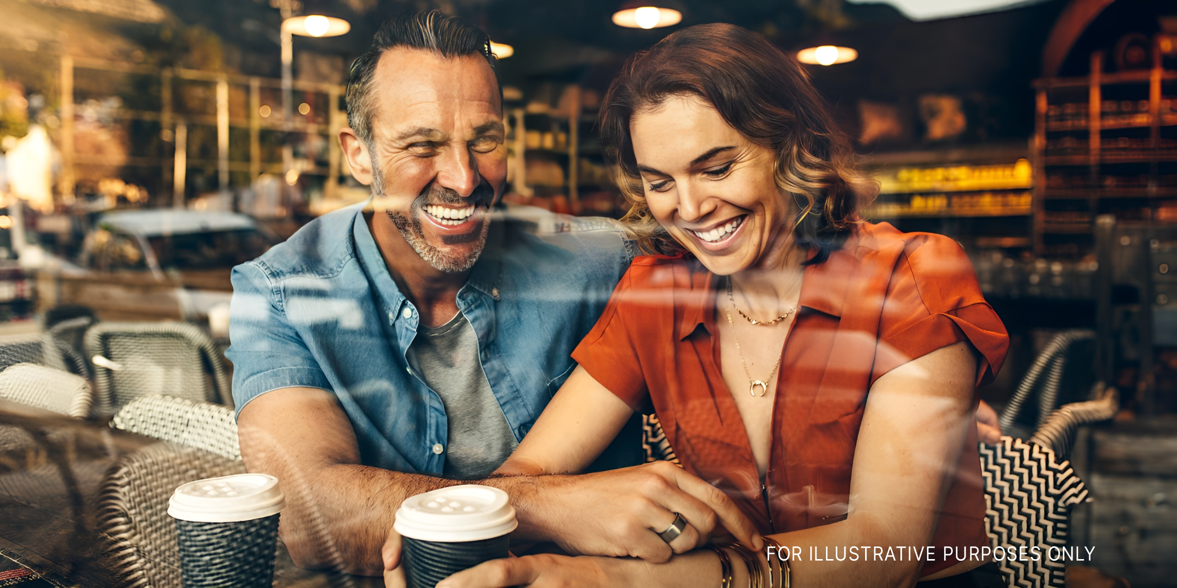 Couple sitting inside café | Shutterstock
