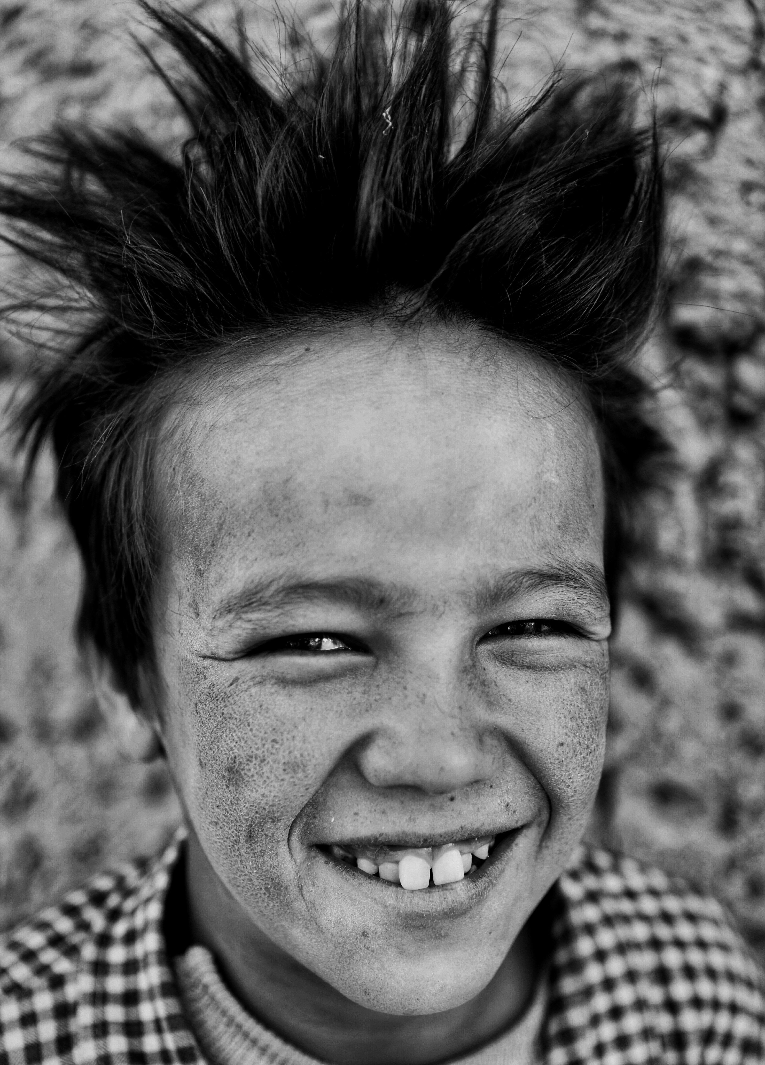 A dirty boy smiling | Source: Unsplash