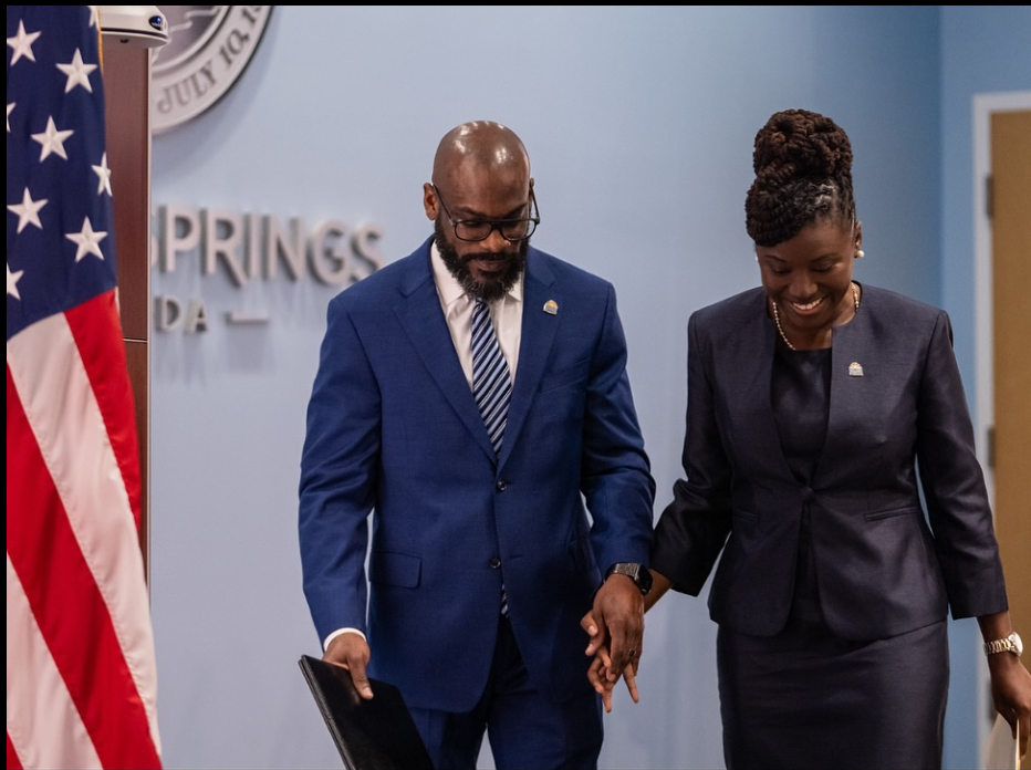 Walking hand in hand in a formal setting, Nancy Metayer Bowen and her husband Stephen Bowen share a quiet, supportive moment, both dressed in coordinated professional attire as they step forward together. | Source: Facebook/Nancy Metayer Bowen
