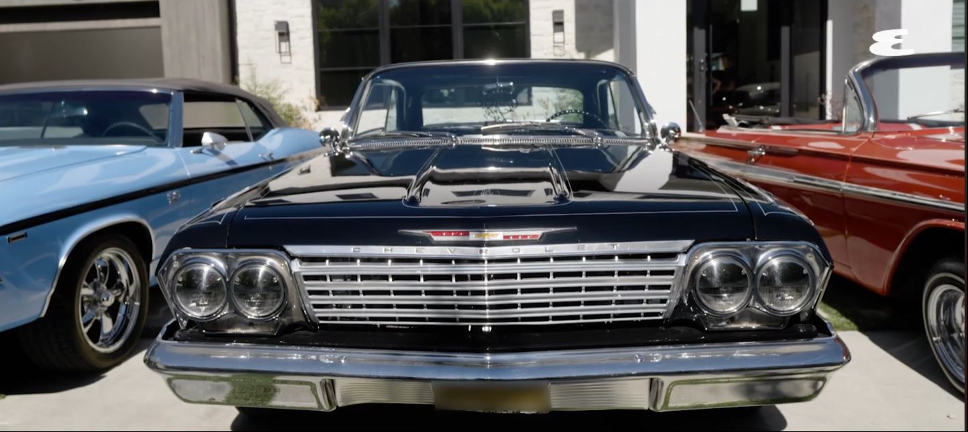 The front end of Wiz Khalifa's 1962 Chevrolet Impala, a black lowrider equipped with hydraulic switches, custom upgrades, and enough power to perform standing three-wheel lifts. | Source: YouTube/Esquire