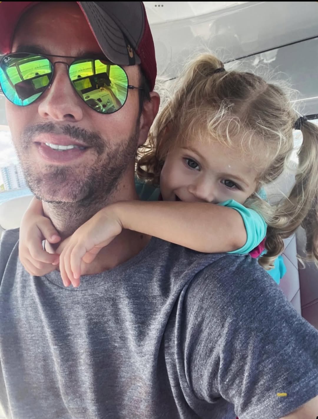 Enrique and Mary Iglesias posing for a selfie inside a car, from a post celebrating Father's Day dated June 16, 2024 | Source: Instagram/annakournikova