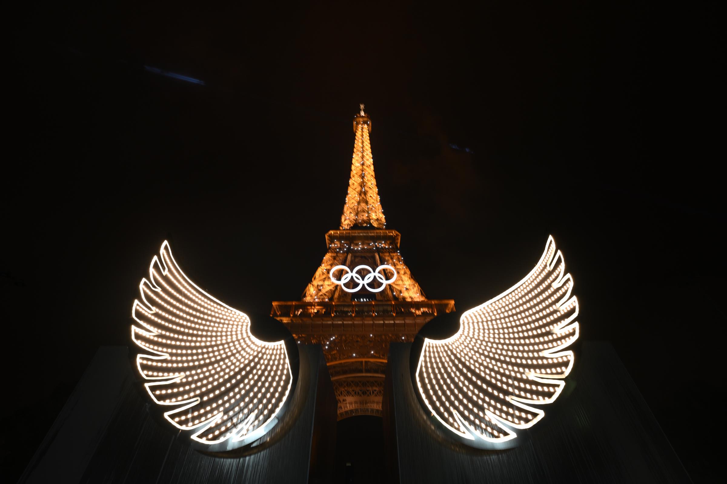 A general view shows the Eiffel Tower with illumated wings in the foreground during the Opening Ceremony of the Olympic Games Paris 2024 in Paris, France, on July 26, 2024. | Source: Getty Images