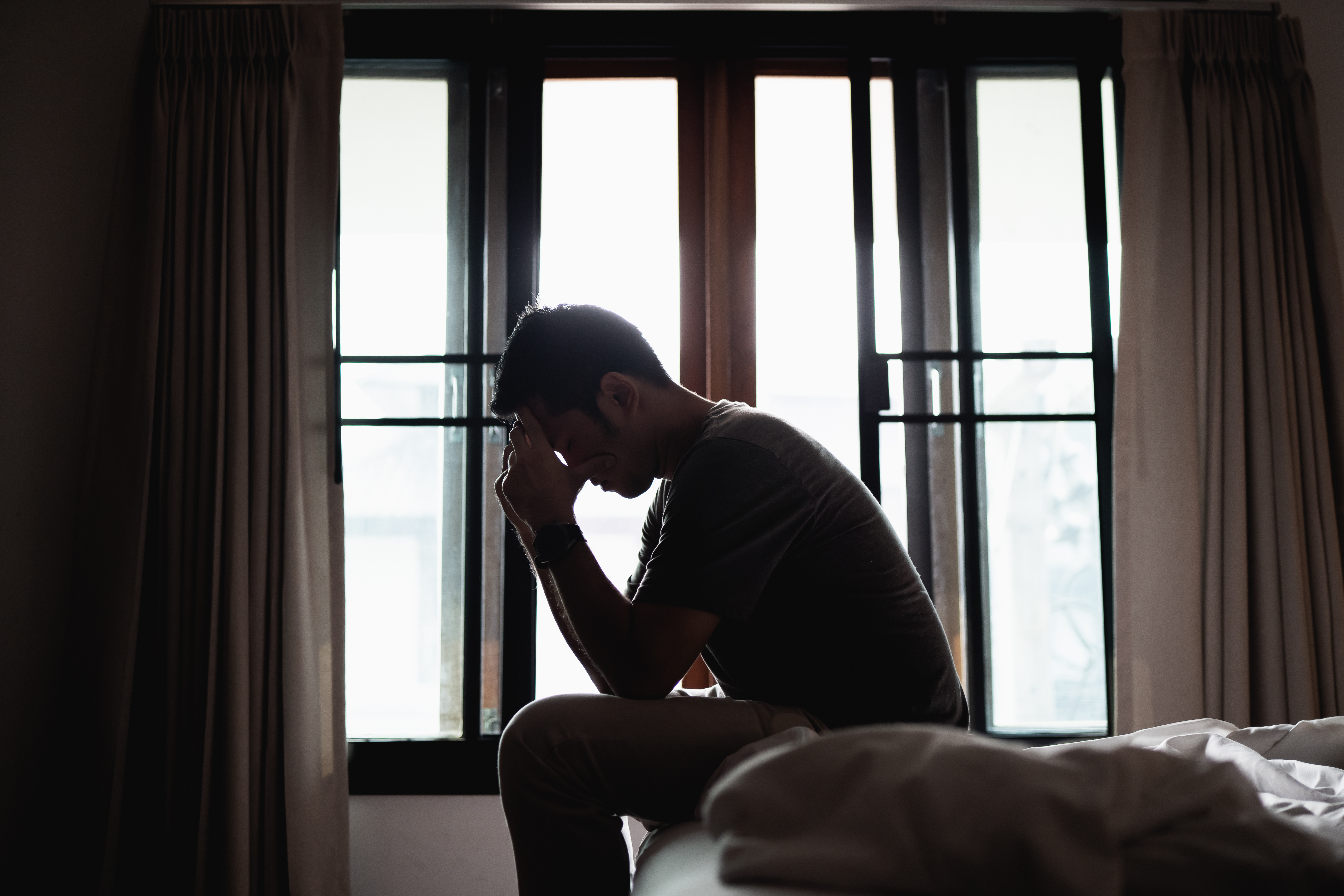 Silhouette depressed man | Source: Shutterstock