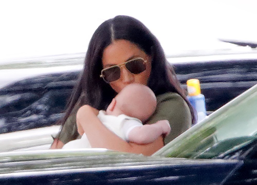 Duchess Meghan cradling Archie at the King Power Royal Charity Polo Day on July 11, 2019 | Photo: Getty Images