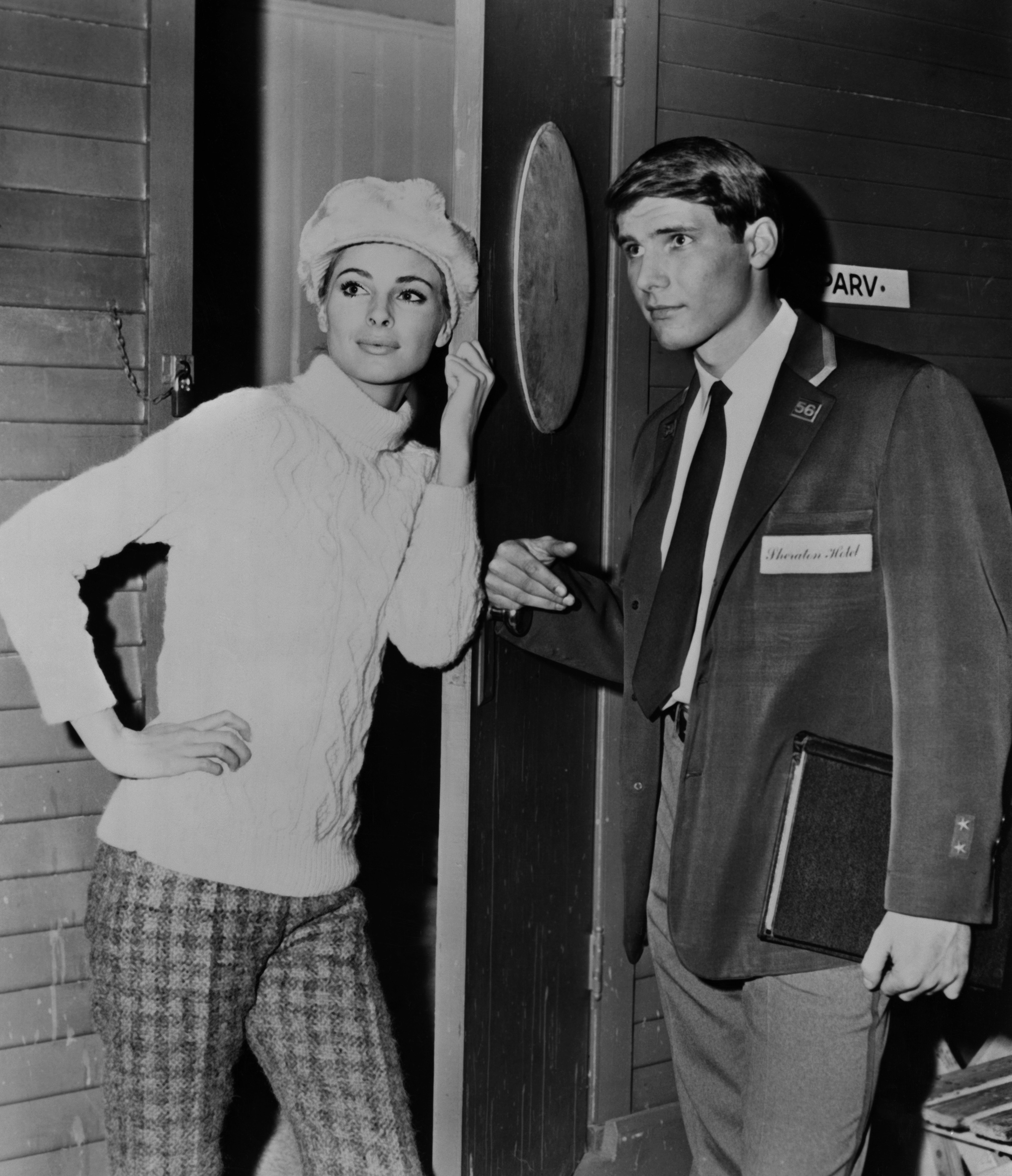 A youthful Harrison Ford looks incredibly sharp in 1966 on the set of "Dead Heat on a Merry-Go-Round." Standing alongside co-star Camilla Sparv, the future action hero was already showing off the effortless charm that would captivate audiences for the next 60 years. | Source: Getty Images