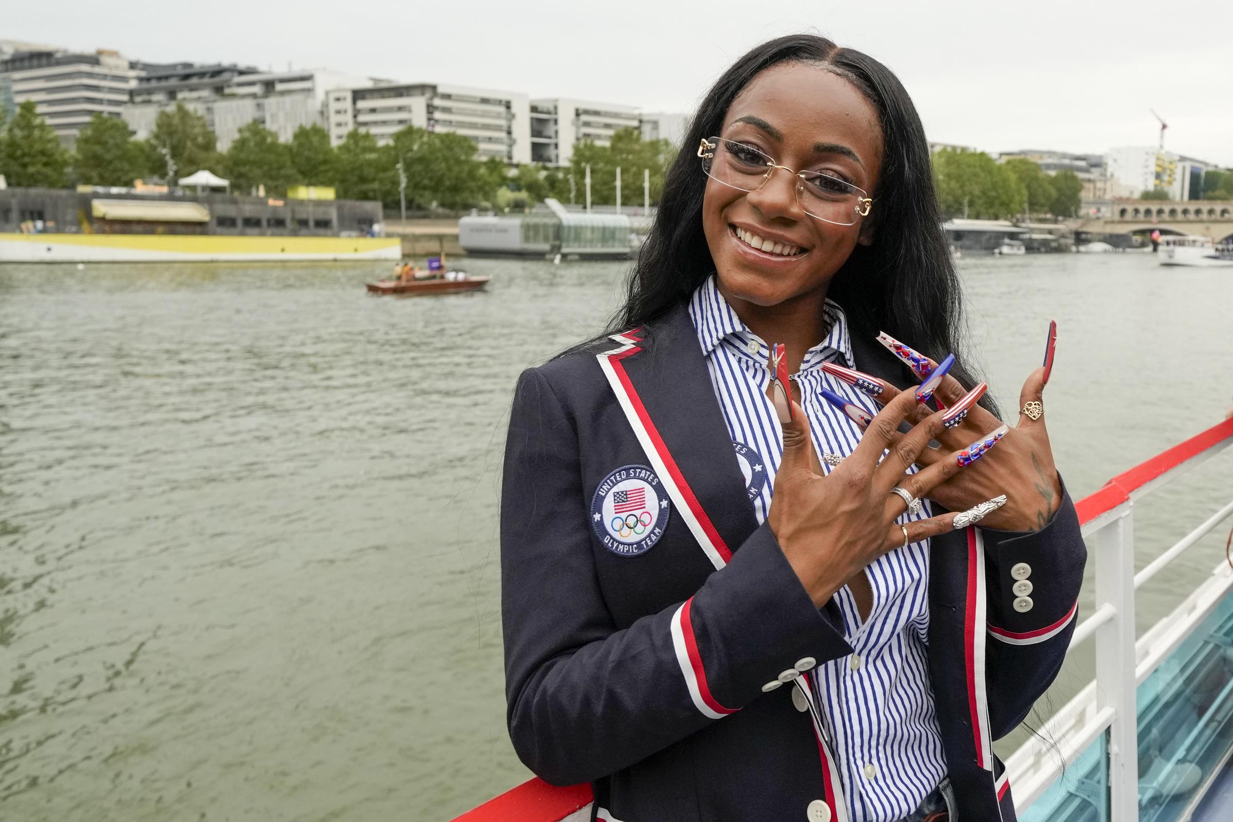 Sha'Carri Richardson poses for a photo while riding with teammates on a boat during the Opening Ceremony of the Olympic Games Paris 2024 on July 26, 2024, in Paris, France. | Source: Getty Images