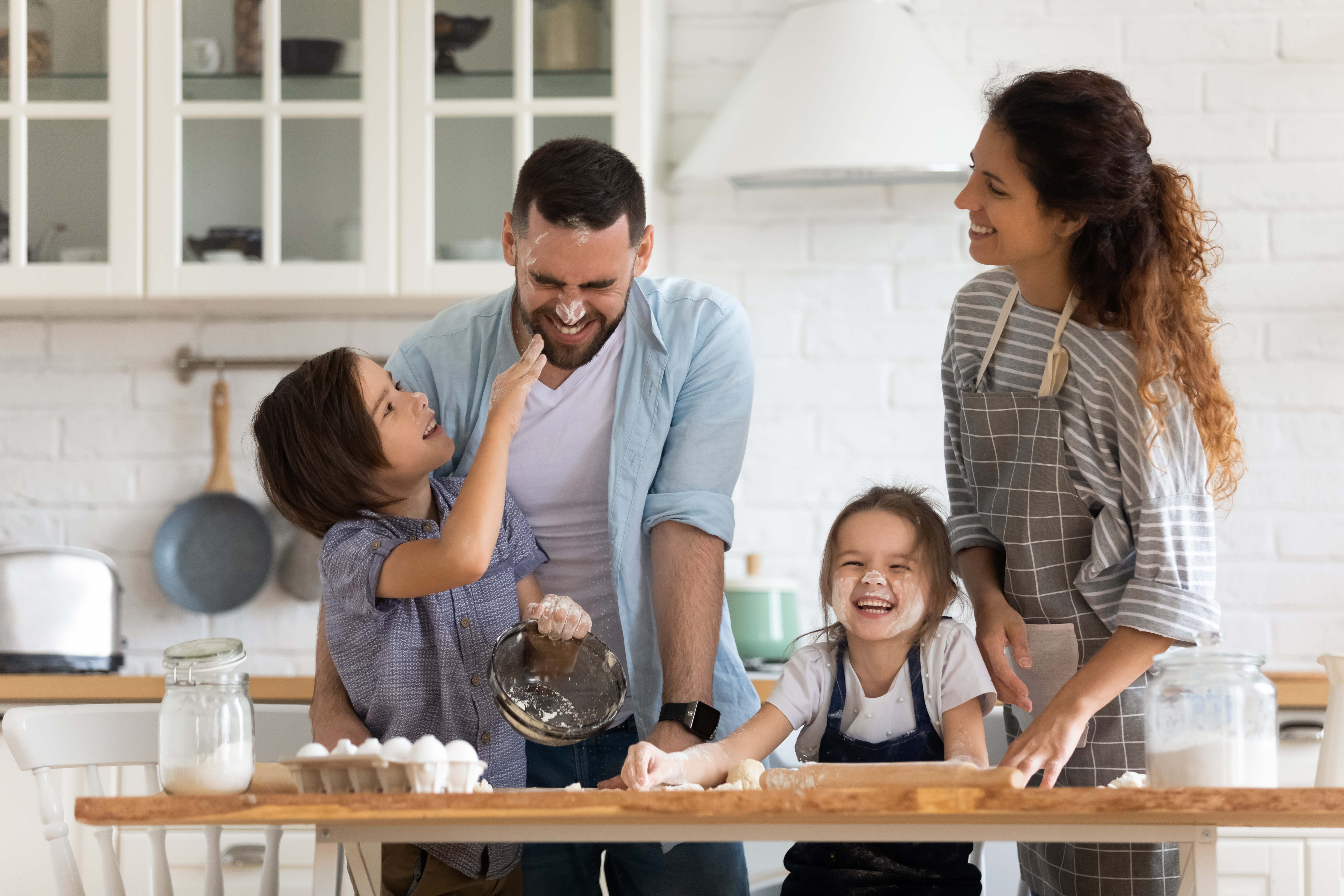 A couple playing with their daughters | Source: Shutterstock