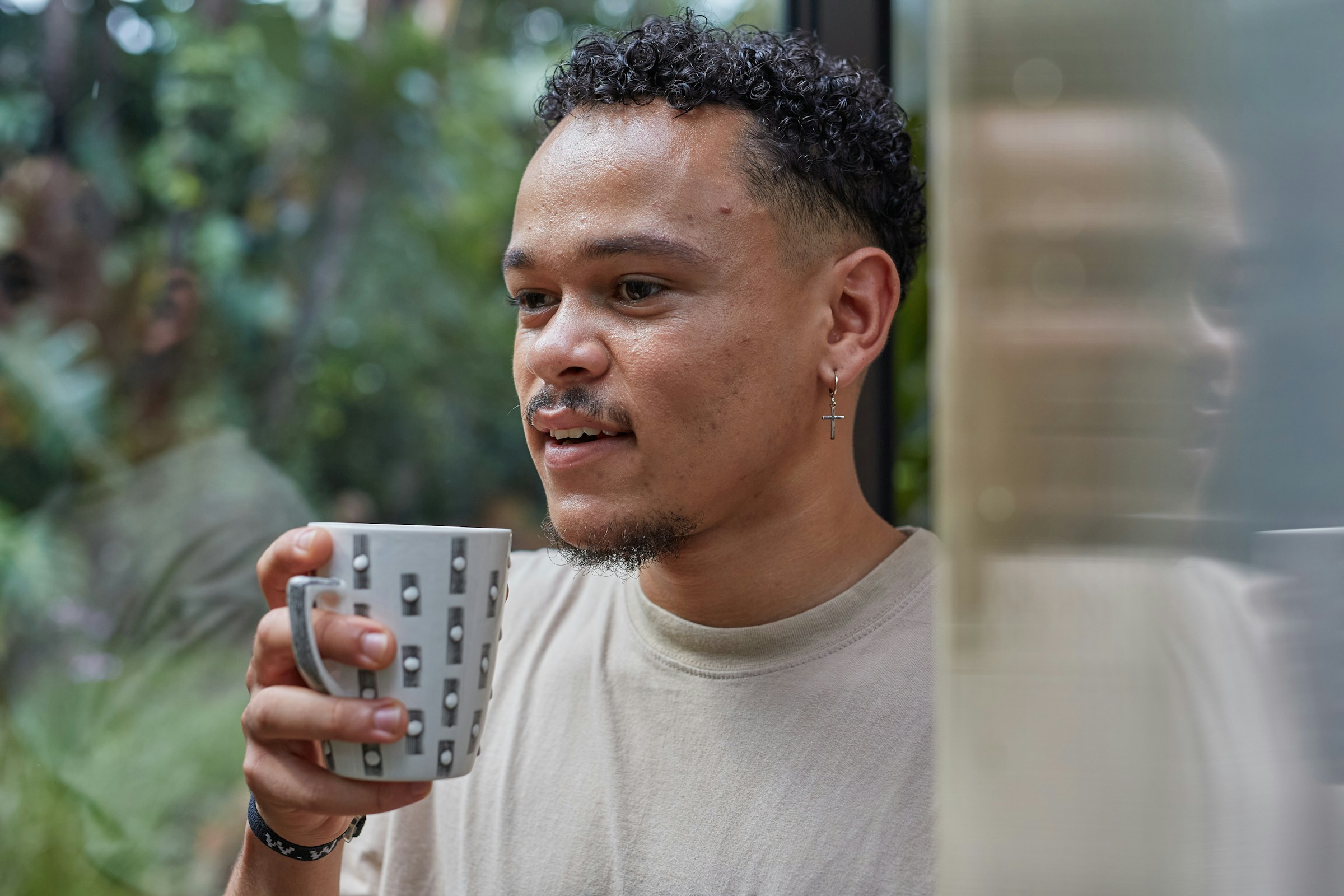 A thoughtful man holding a cup of coffee | Source: