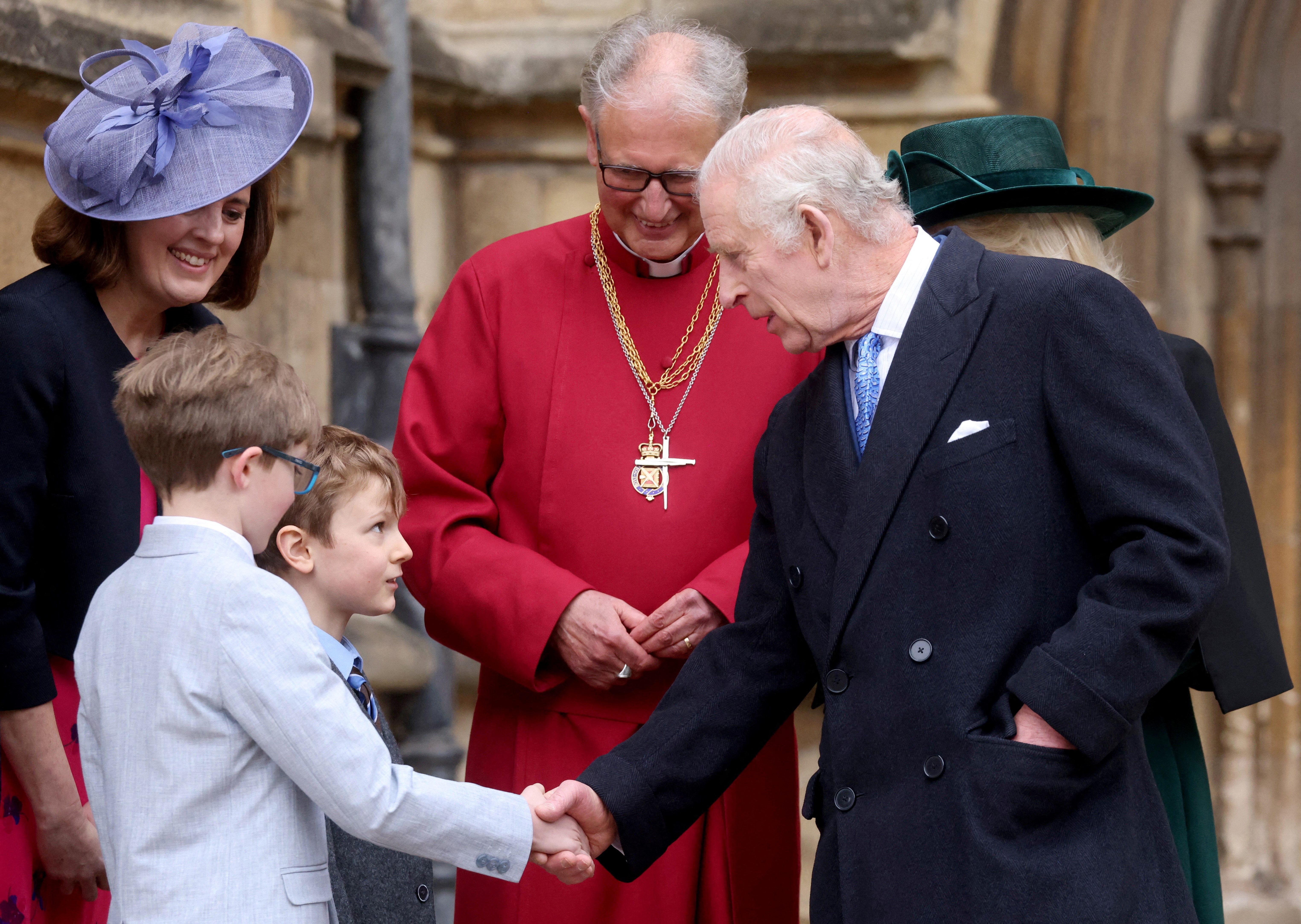 King Charles shaking hands with his young well-wishers as he leaves St. George's Chapel in Windsor, on March 31, 2024 | Source: Getty Images