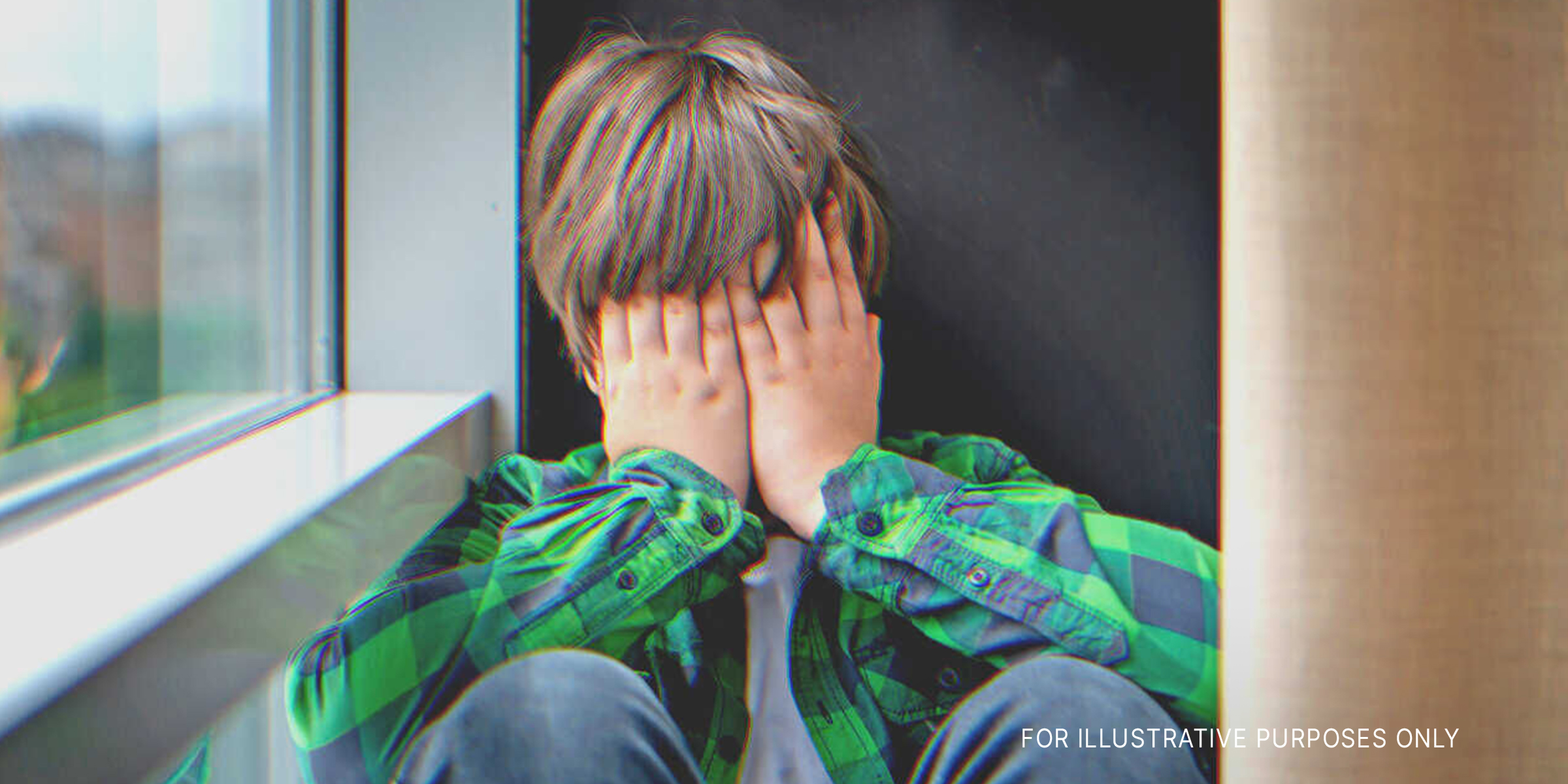 A boy covering his face | Source: Shutterstock