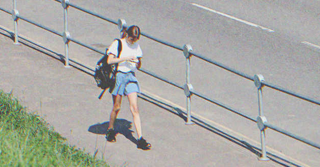 Teen girl walking on the road | Source: Shutterstock