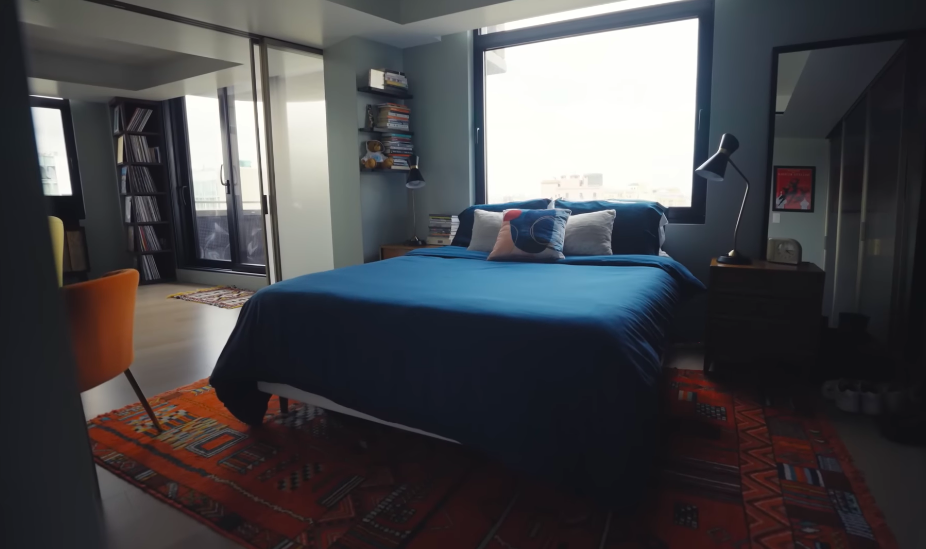 Another angle reveals how generous Sophia's space really is, with windows, books and an adjoining outdoor connection.The room feels more like a self-contained retreat than a spare bedroom. | Source: YouTube/Architectural Digest