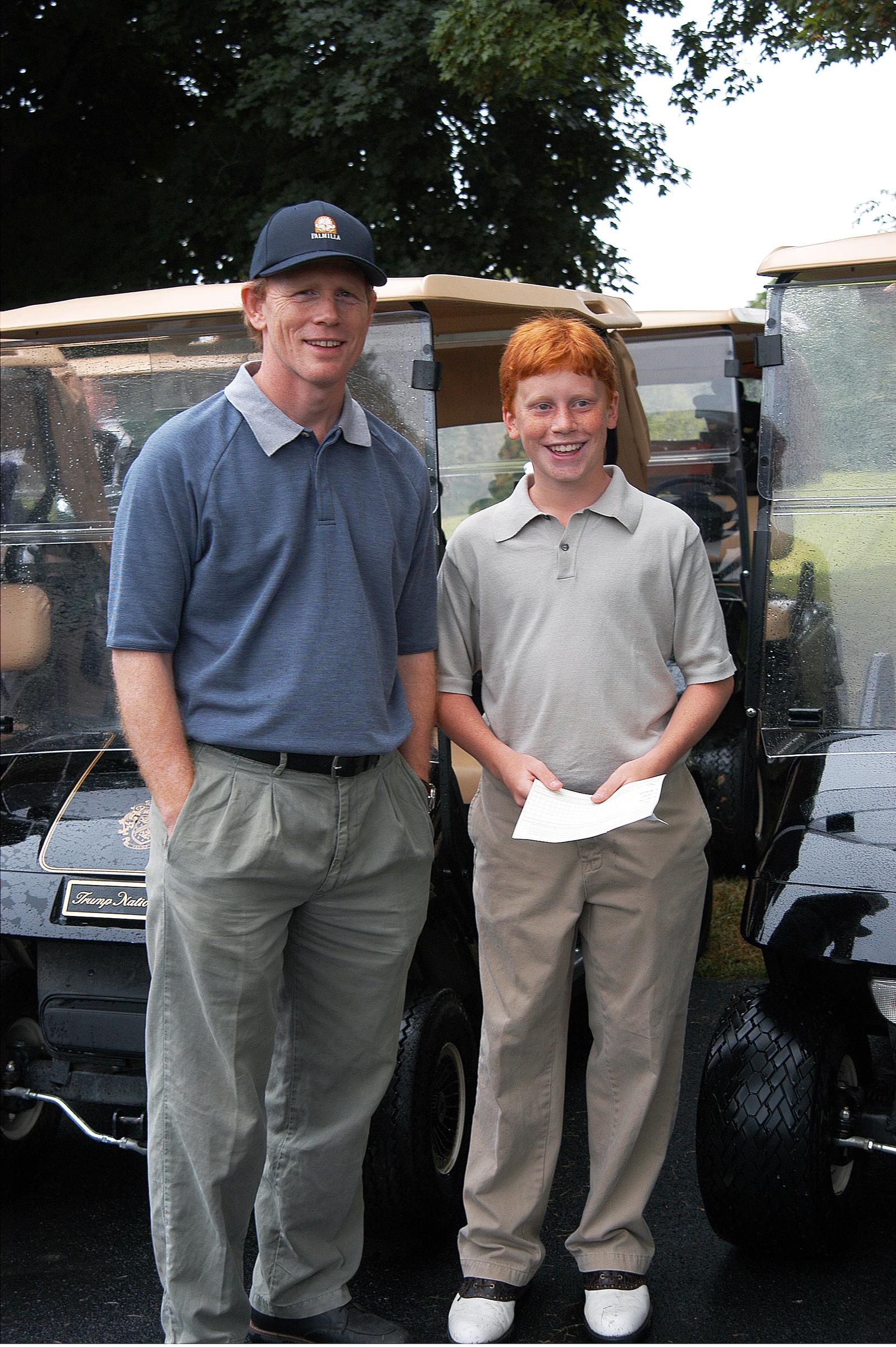 A Hollywood director and his son on hand to play a round of golf during opening celebrations for the Trump National Golf Club on July 27, 2002 | Source: Getty Images