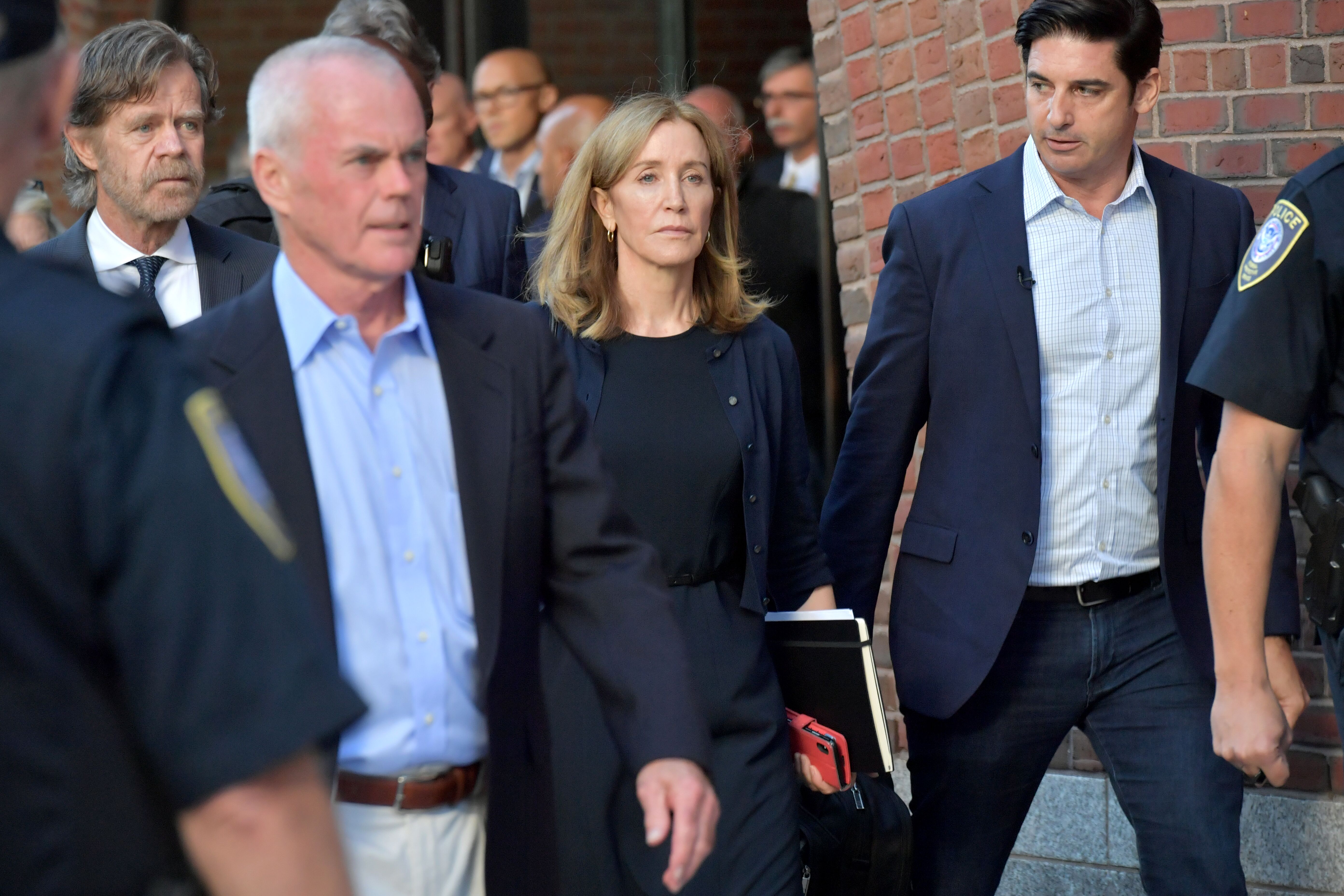 Felicity Huffman & husband William Macy exit the court after Huffman’s sentencing on Sept. 13, 2019 in Massachusetts | Photo: Getty Images