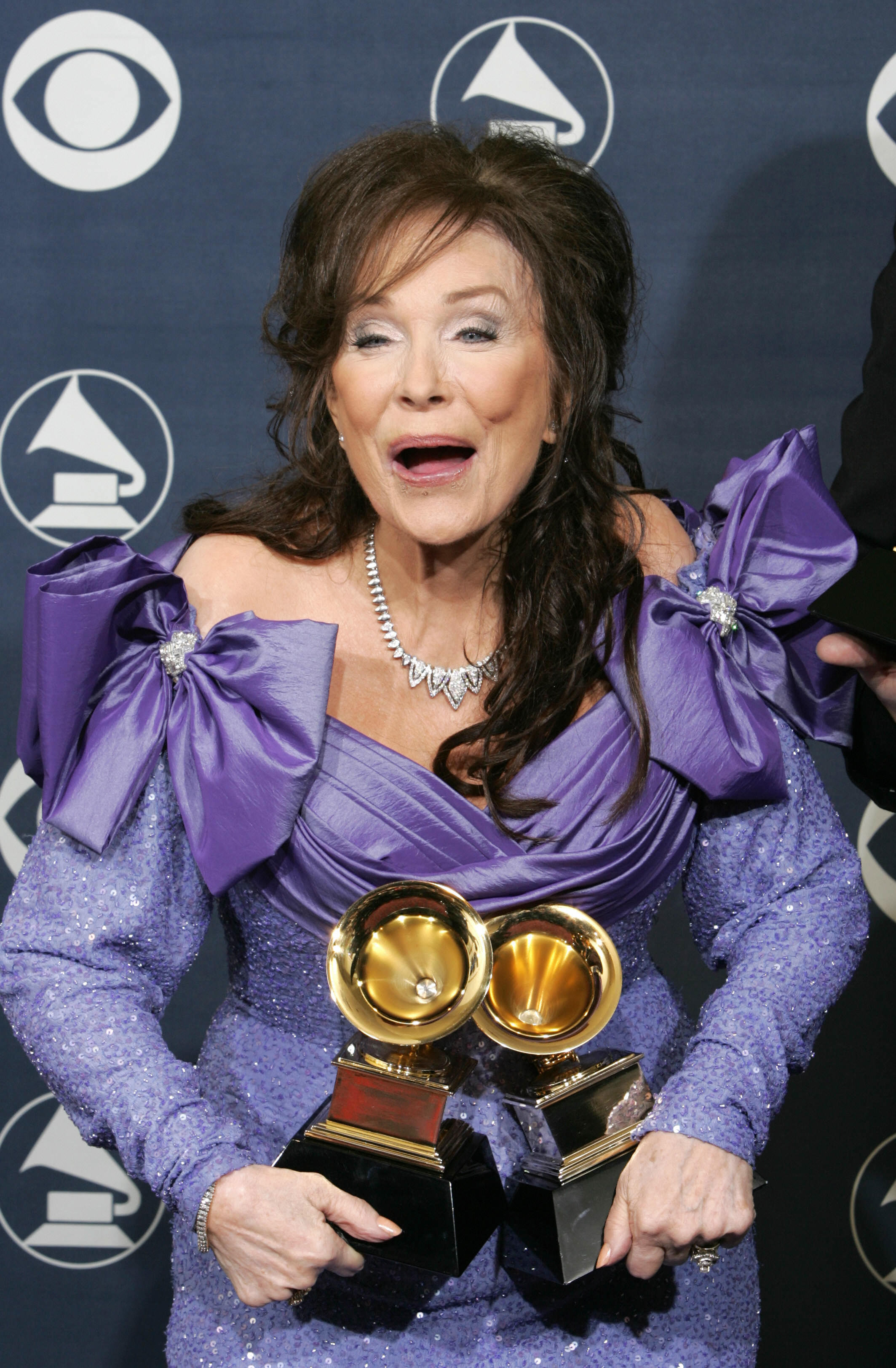 Loretta Lynn poses with the awards she won at the Grammys ceremony in Los Angeles on February 13, 2005. | Source: Getty Images